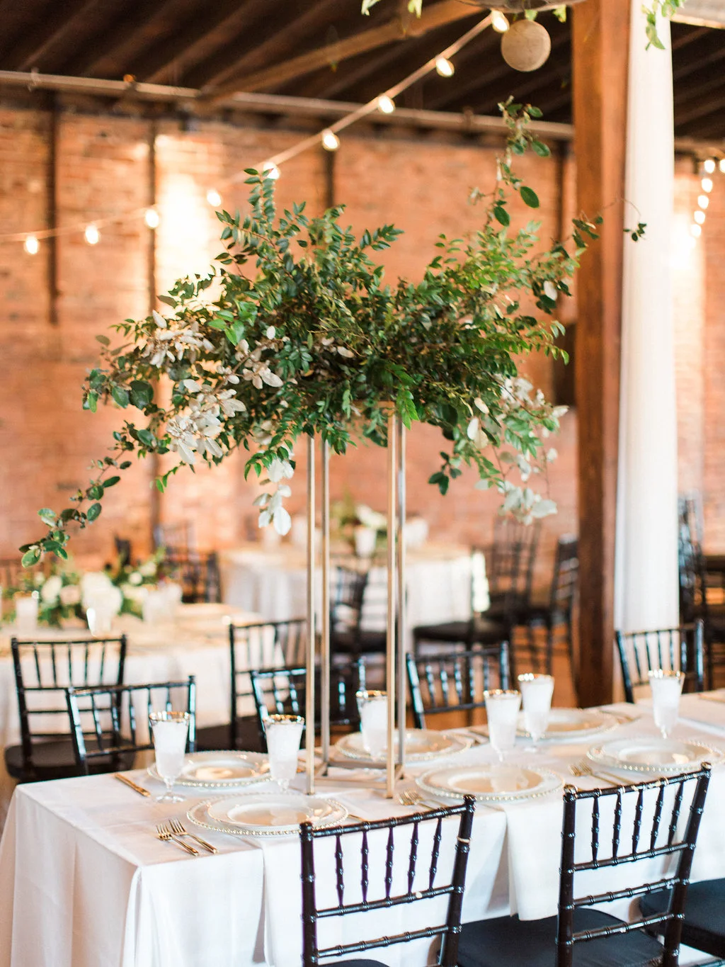 Modern gold stands with lush arrangements of all greenery for the head table // Nashville Wedding Floral Design