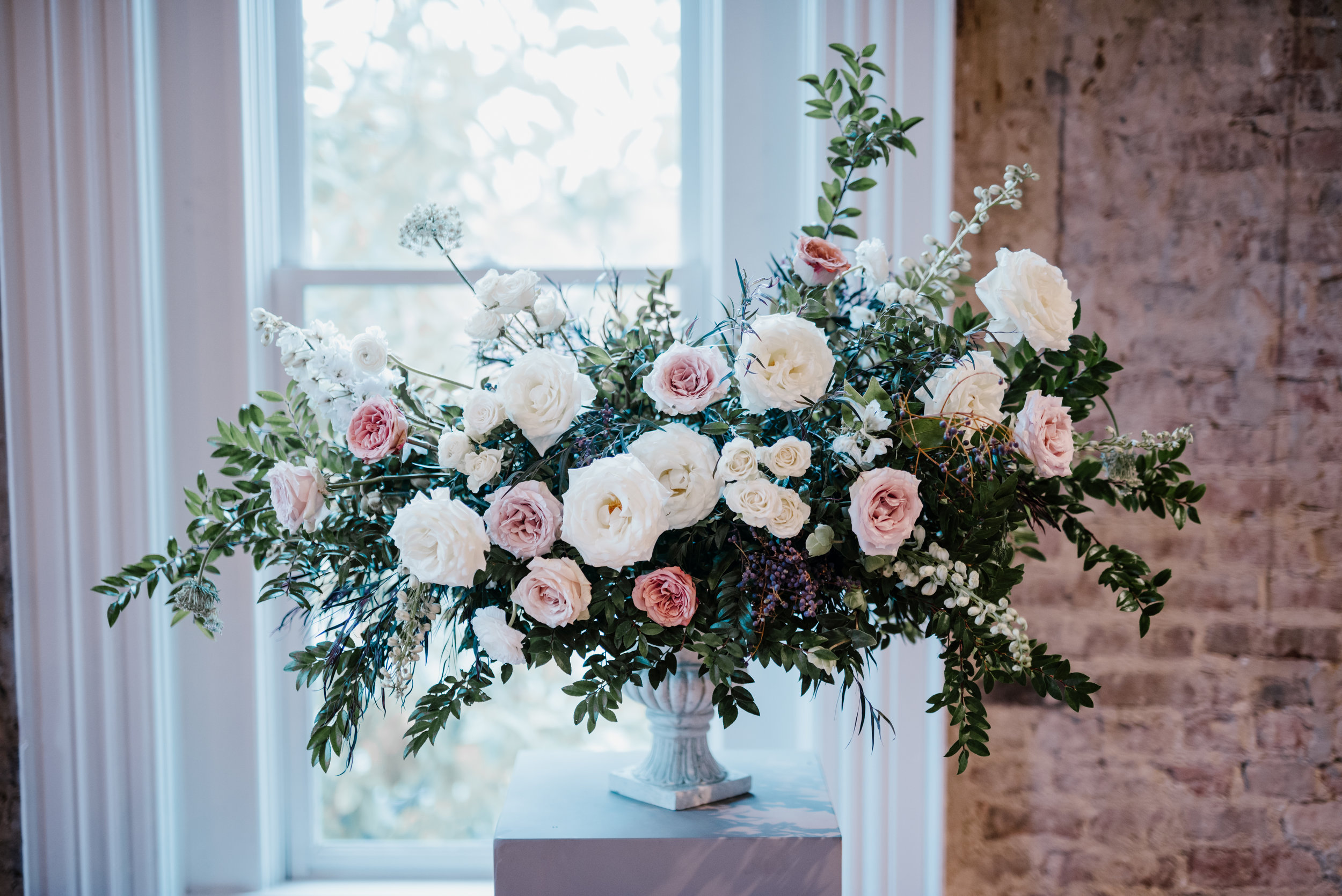 Muted, organic flowers using white garden roses, ranunculus, and lush greenery // Southeastern Wedding Floral Design