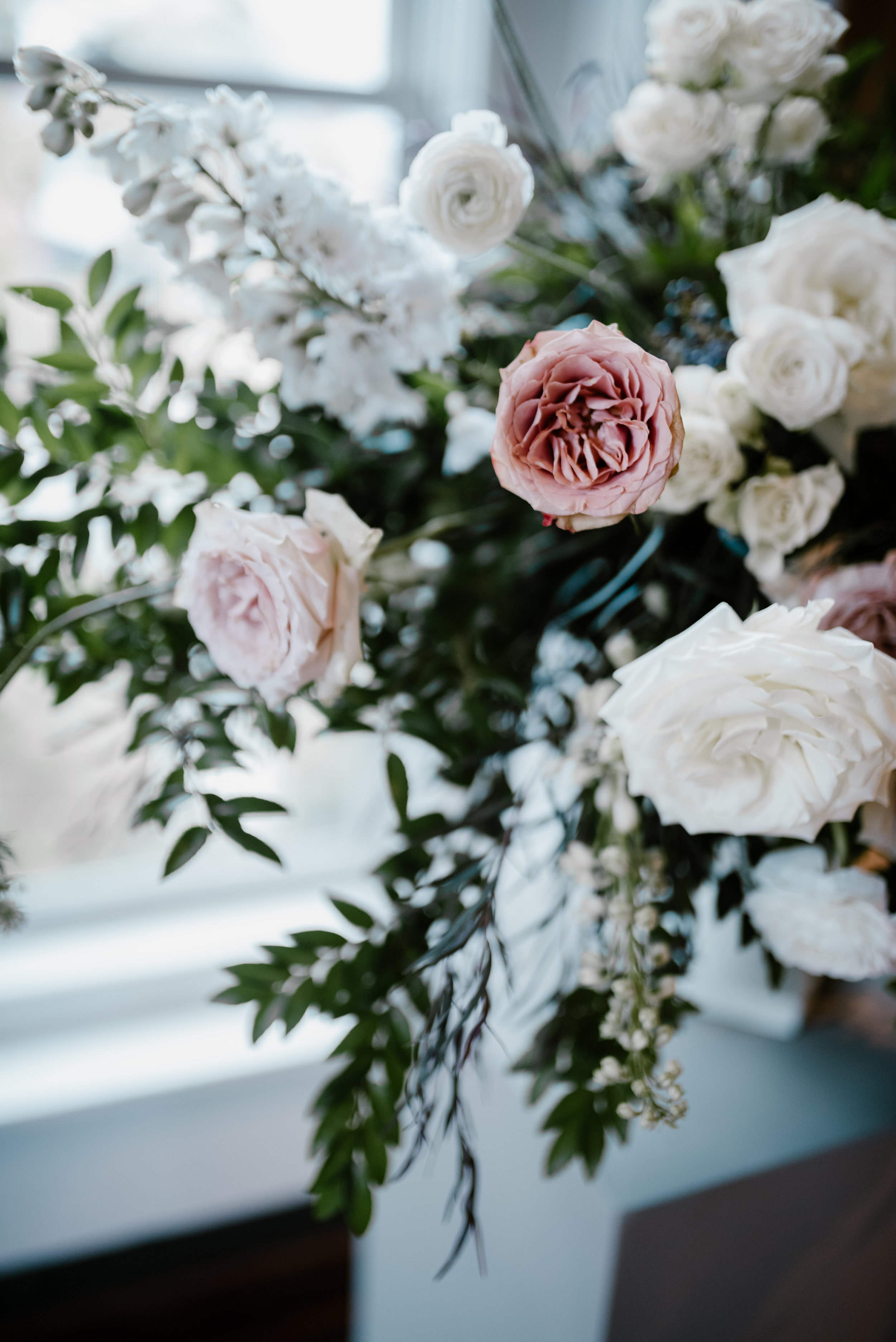 Muted, organic flowers using white garden roses, ranunculus, and lush greenery // Southeastern Wedding Floral Design