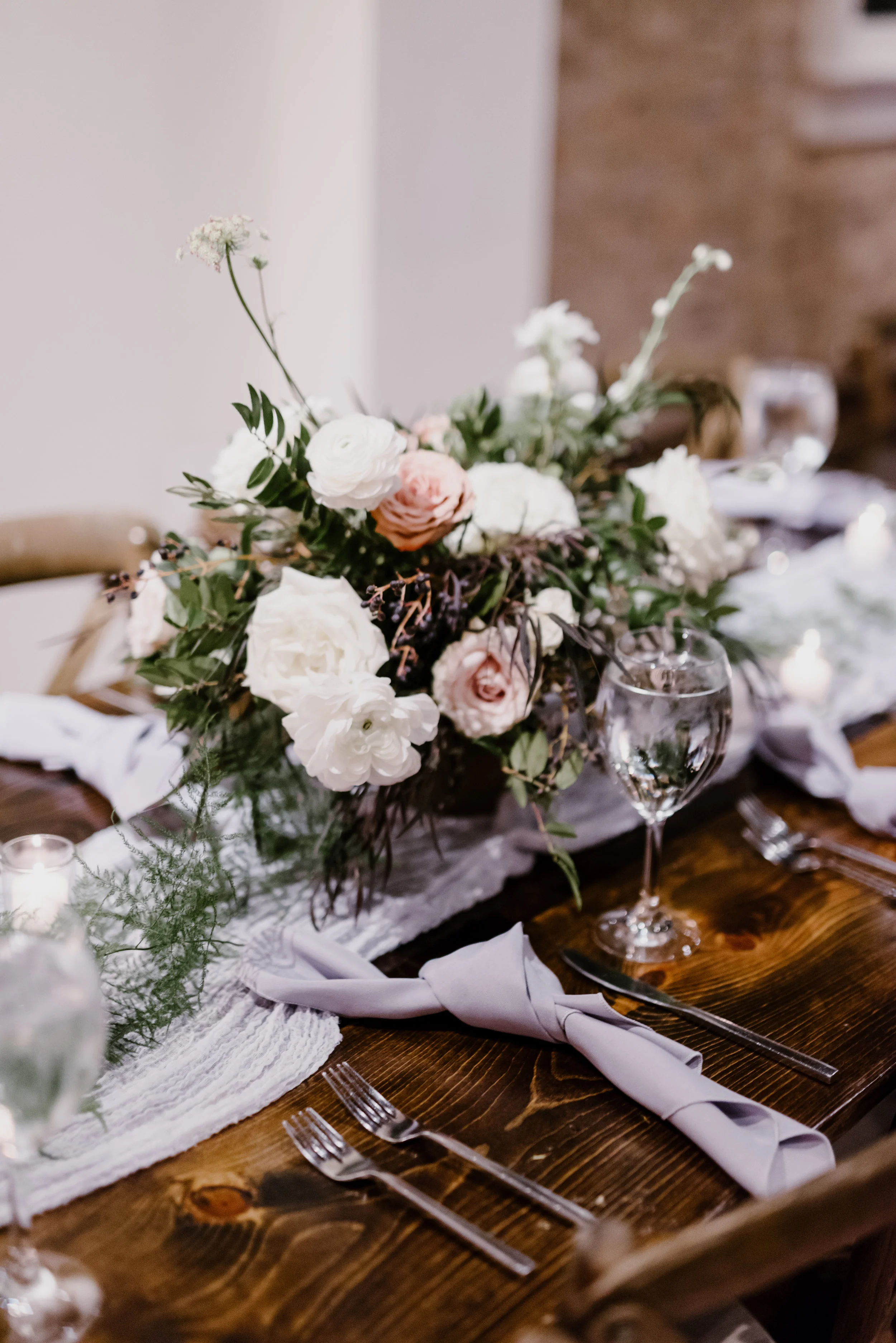 Low, organic centerpiece with garden roses, ranunculus, and trailing greenery // Southeastern Wedding Floral Design