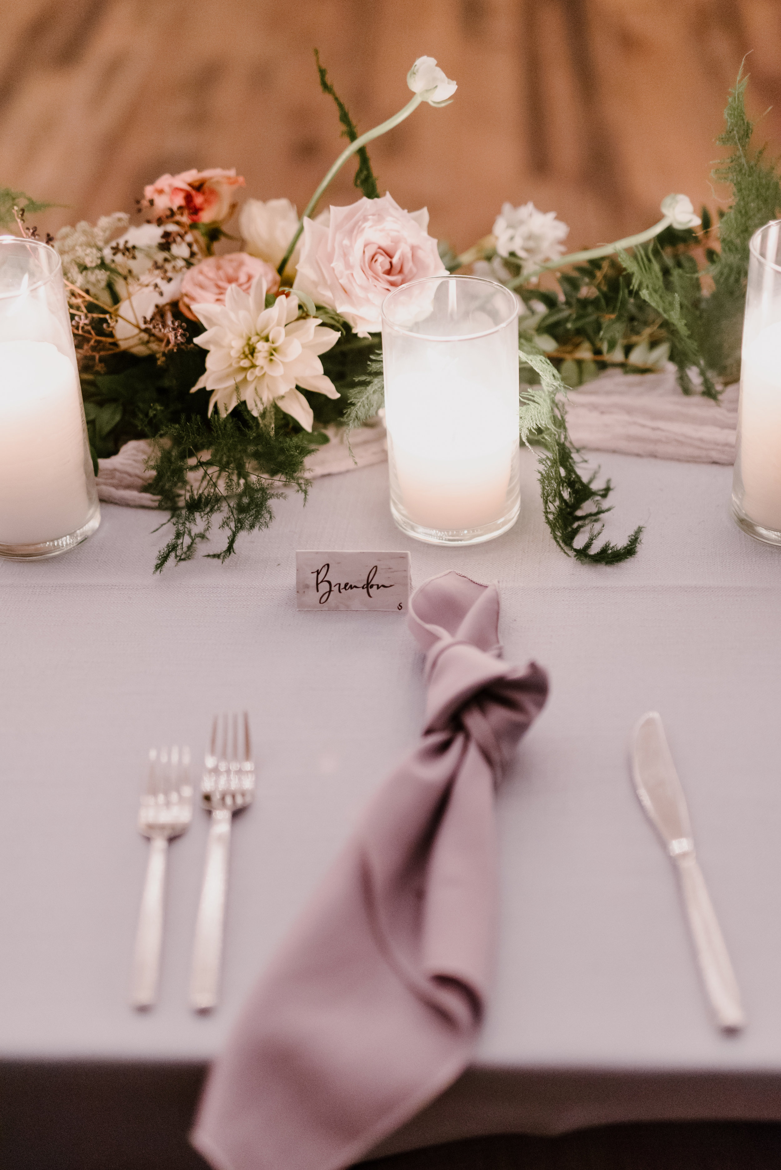 Low, organic centerpiece with garden roses, ranunculus, and trailing greenery // Southeastern Wedding Floral Design