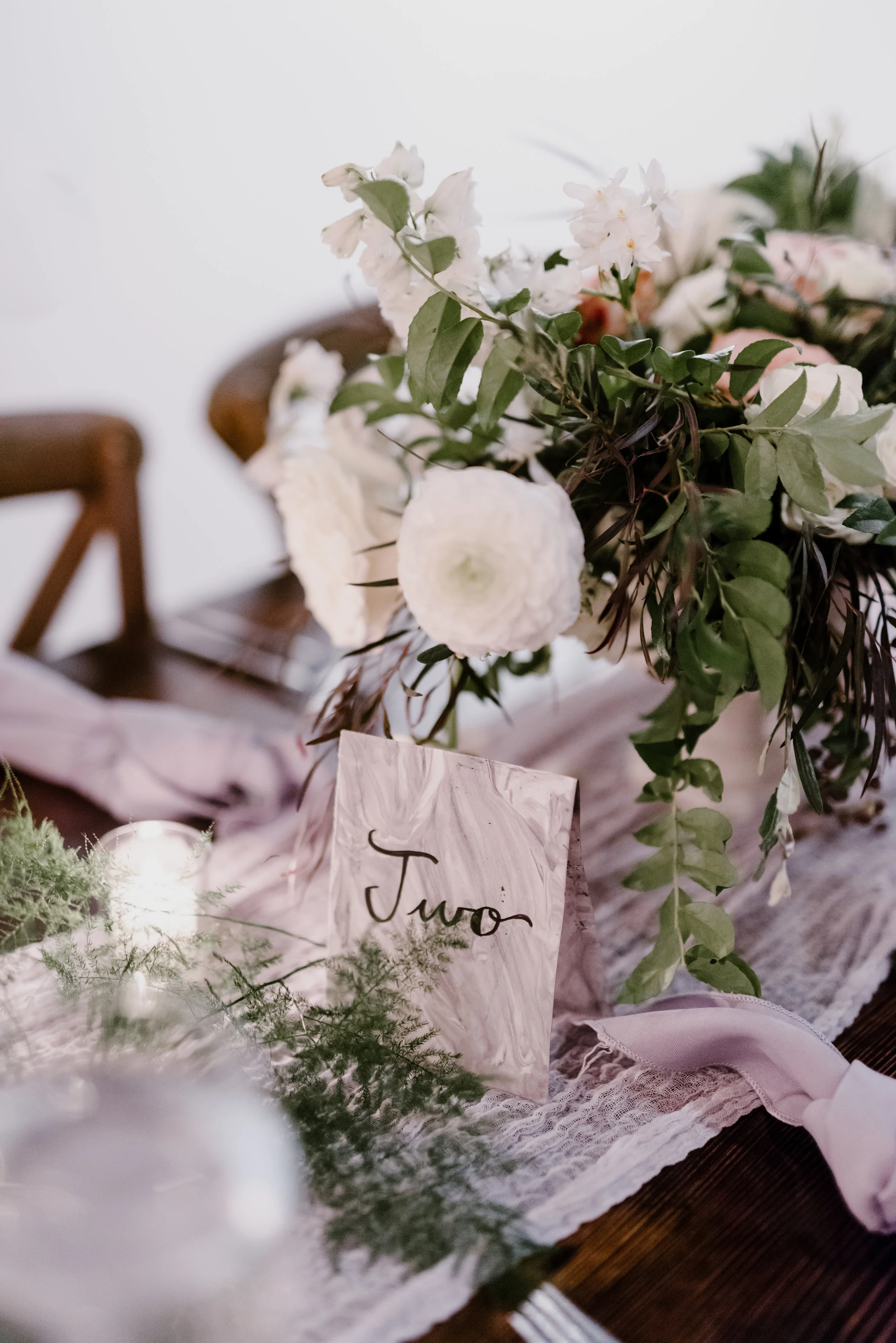 Low, organic centerpiece with garden roses, ranunculus, and trailing greenery // Southeastern Wedding Floral Design