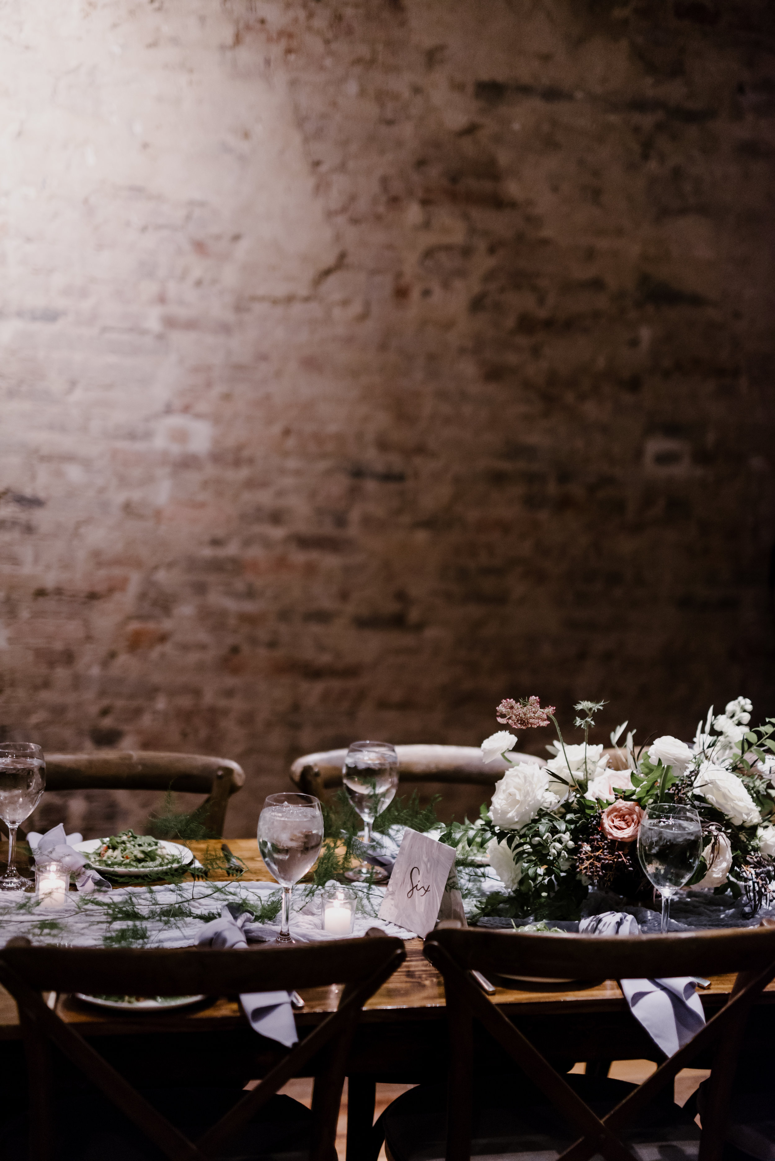 Low, organic centerpiece with garden roses, ranunculus, and trailing greenery // Southeastern Wedding Floral Design