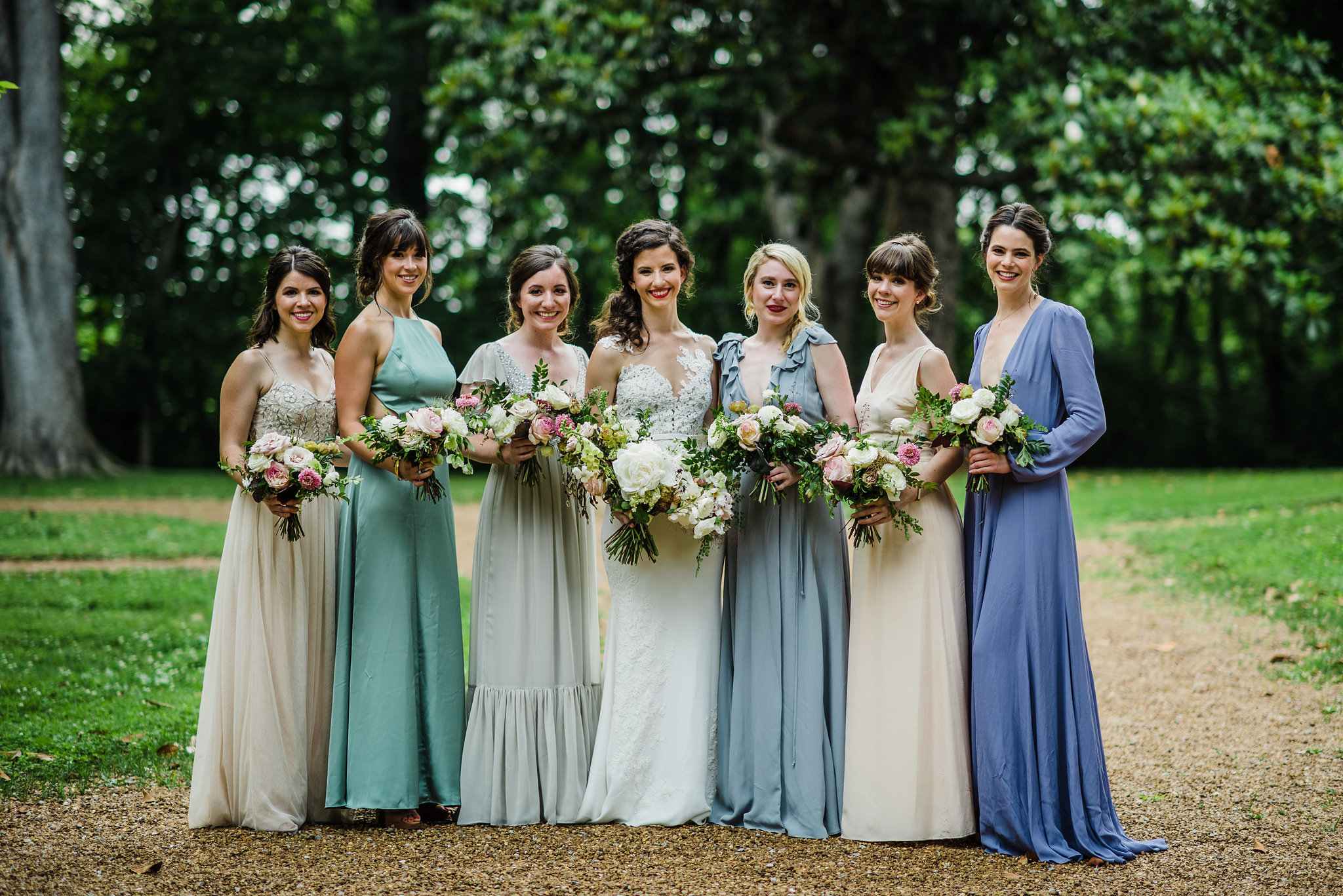 Soft blues and greens mix and match bridesmaid dresses // Garden party wedding with neutral, muted flowers with airy, whimsical greenery and texture // Southeastern Wedding Florist