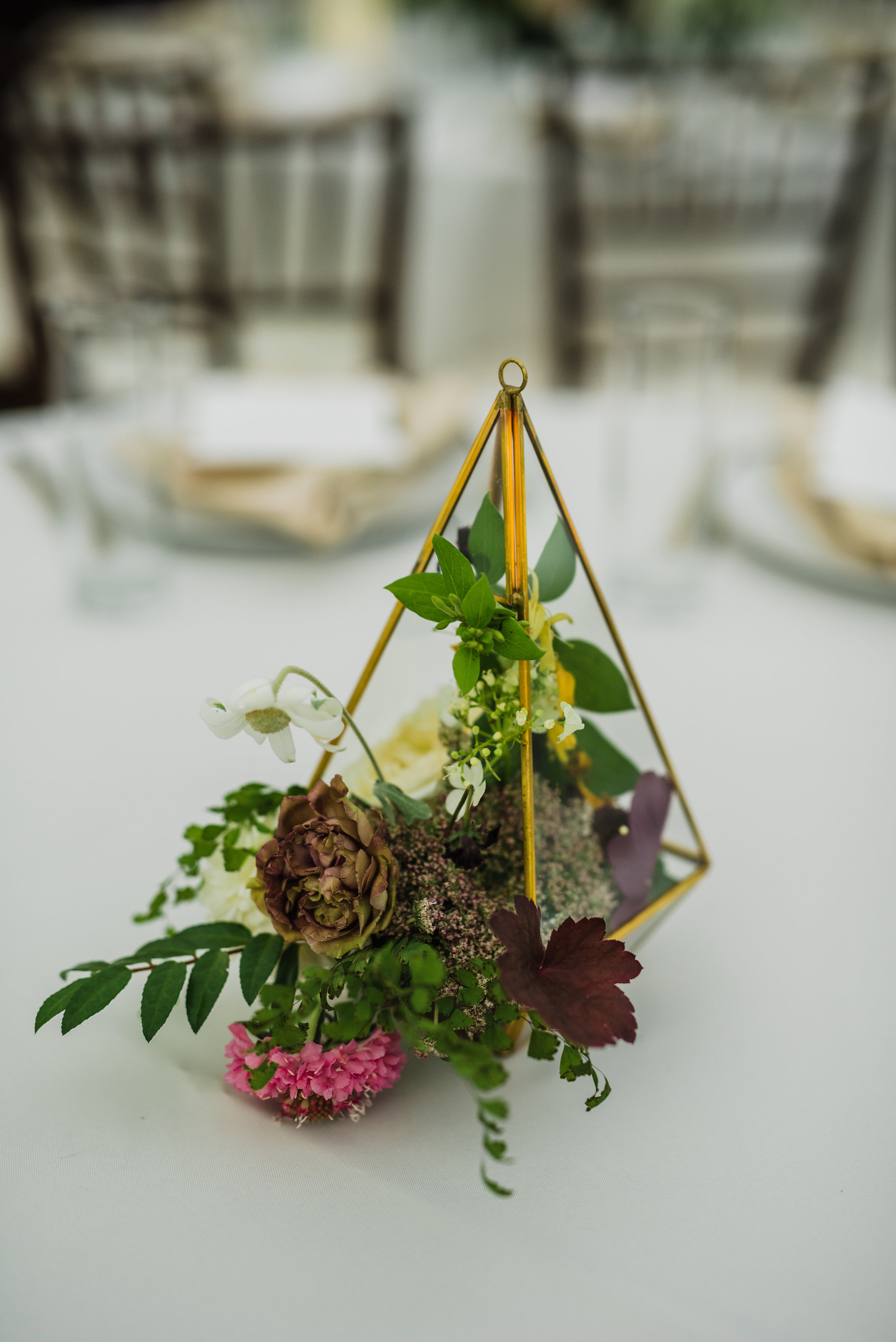 Gold geometric terrarium with muted florals and greenery spilling out // Nashville Wedding Floral Design