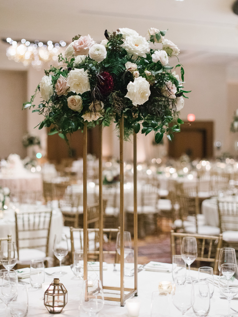 Elevated floral centerpiece with lush greenery, garden roses, and dahlias // Southeastern Wedding Florist