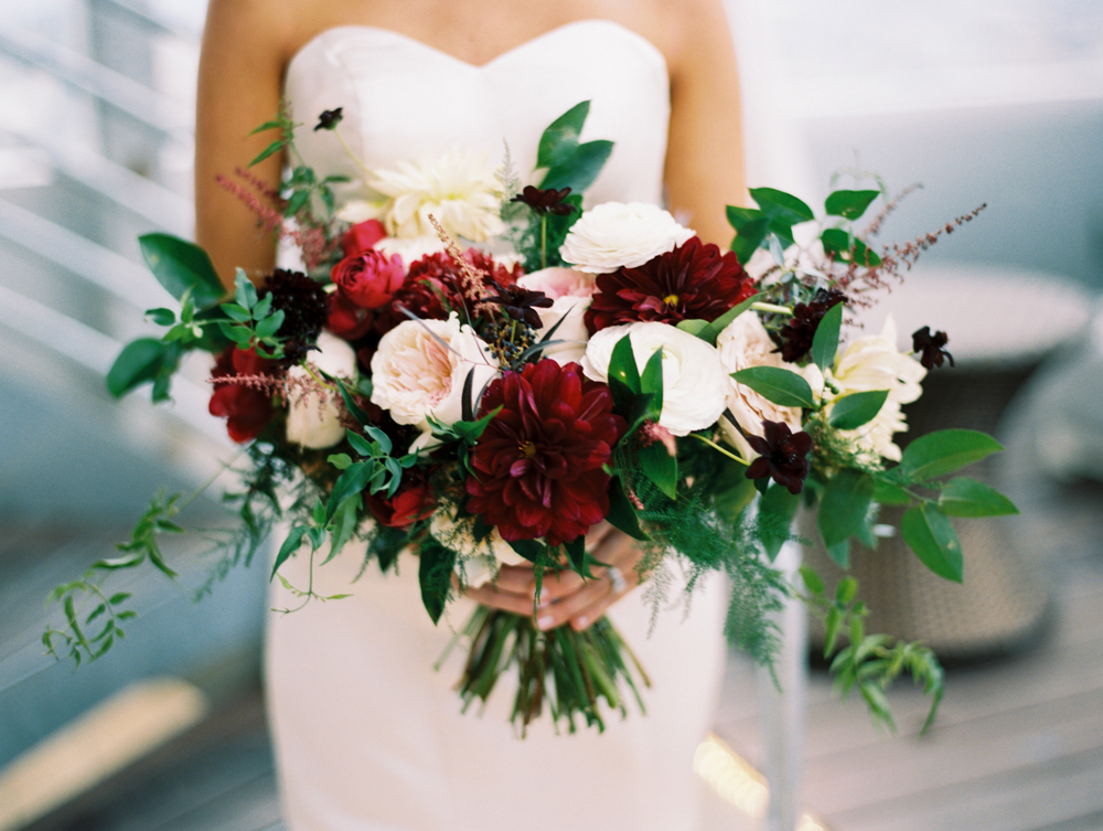 Loose, airy bridal bouquet with dahlias and garden roses in shades of burgundy and cream // Nashville Wedding Floral Design
