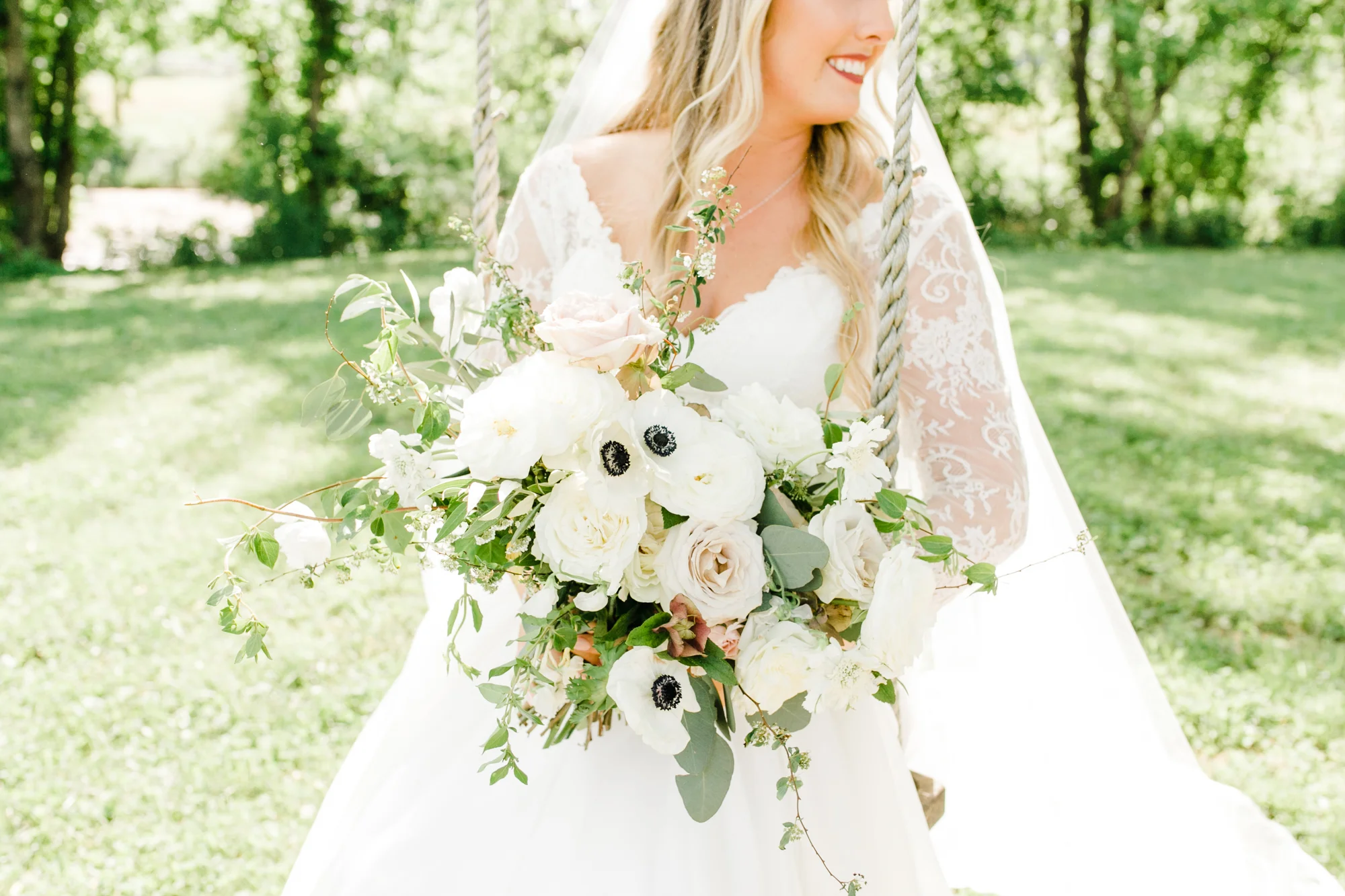 Lush, untamed bride's bouquet with anemones, blush and white garden roses, jasmine, and trailing greenery // Nashville Wedding Florist