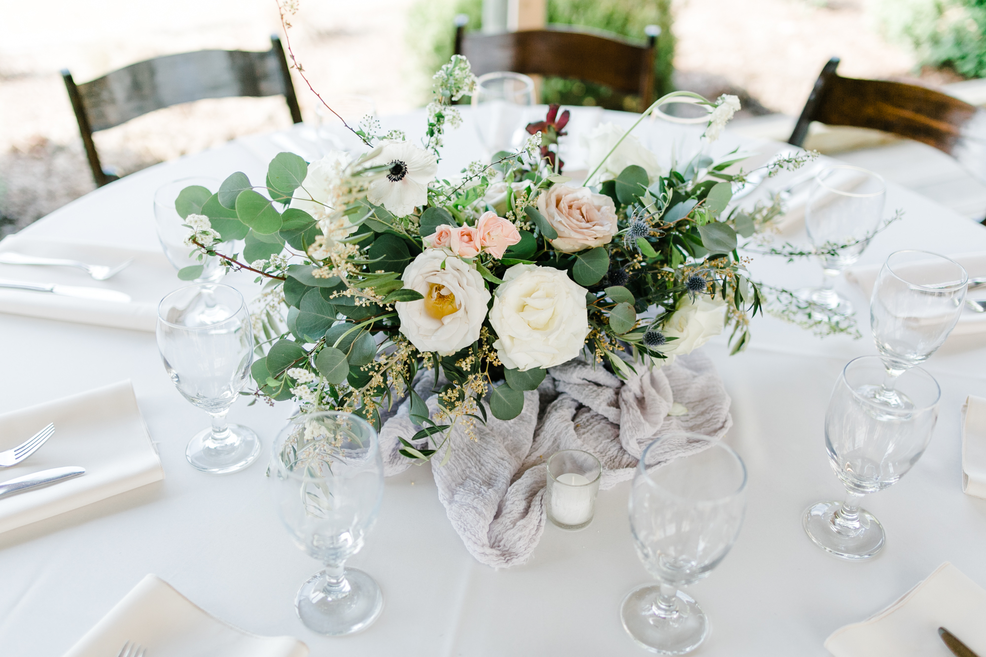Low, garden urn centerpiece with blush and neutral floral and natural greenery // Nashville Wedding Florist