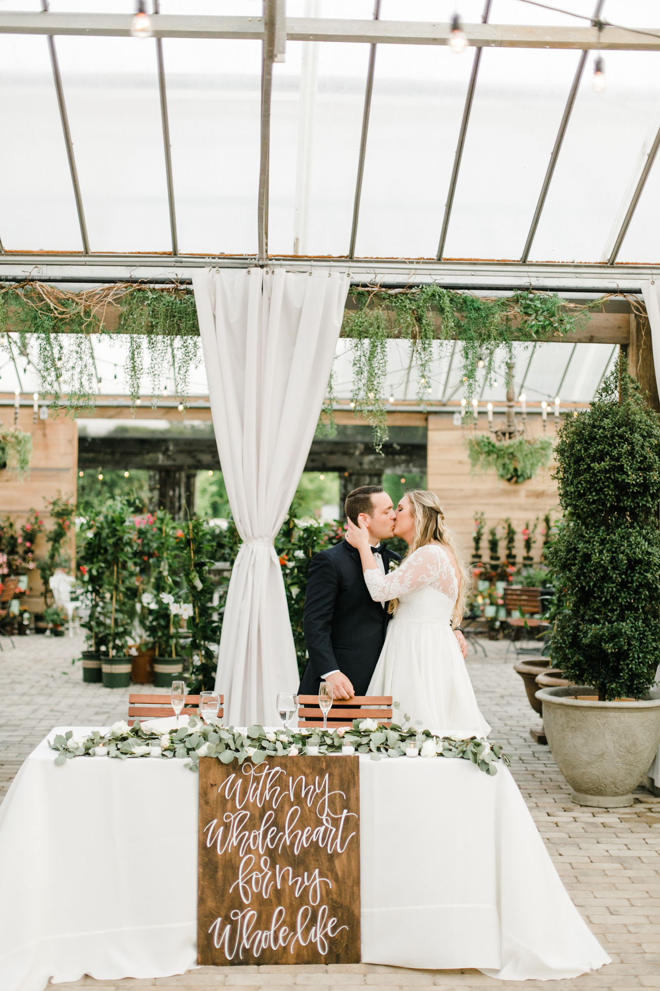Sweetheart table with lush eucalyptus garland // Nashville Wedding Florist
