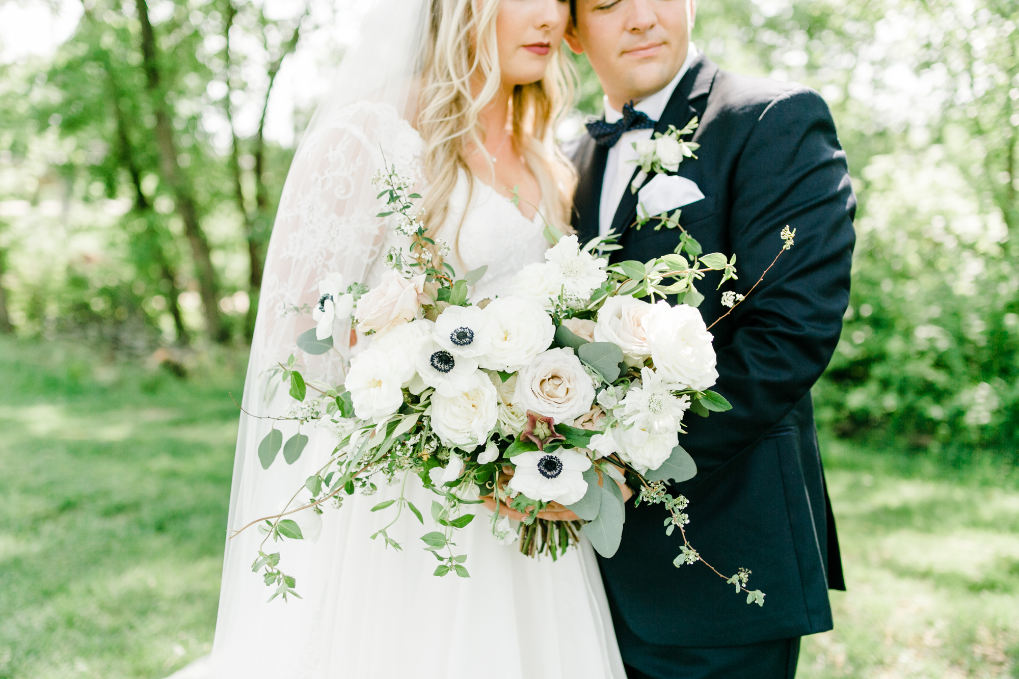Asymmetrical, airy bridal bouquet with anemones, spirea, and garden roses // Nashville Wedding Floral Design