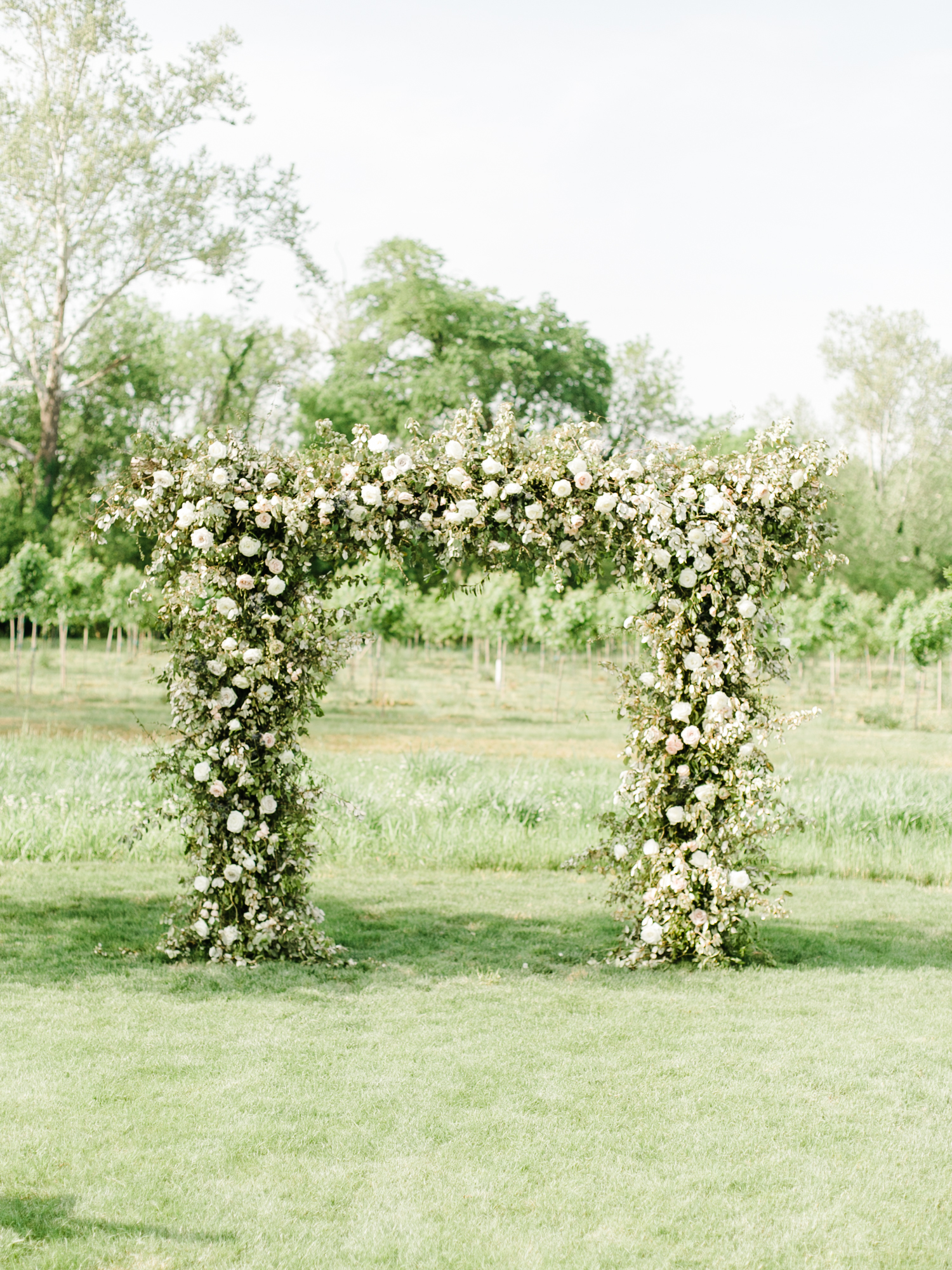 Large wedding arch with lush greenery and white and blush florals // Nashville Wedding Florist