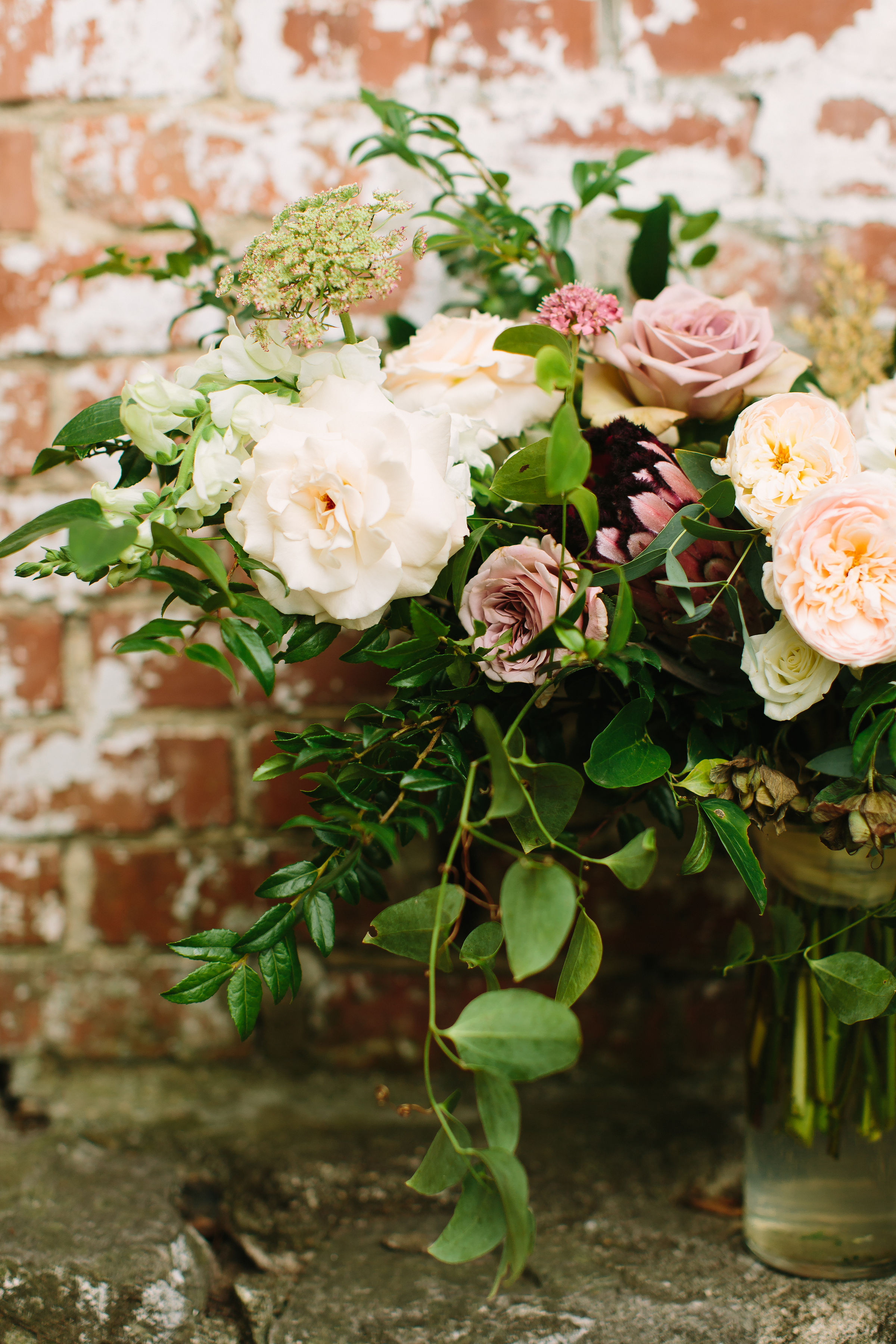 Lush bridal bouquet with garden roses and ranunculus in hues of cream and dusty mauve // Nashville Wedding Floral Design
