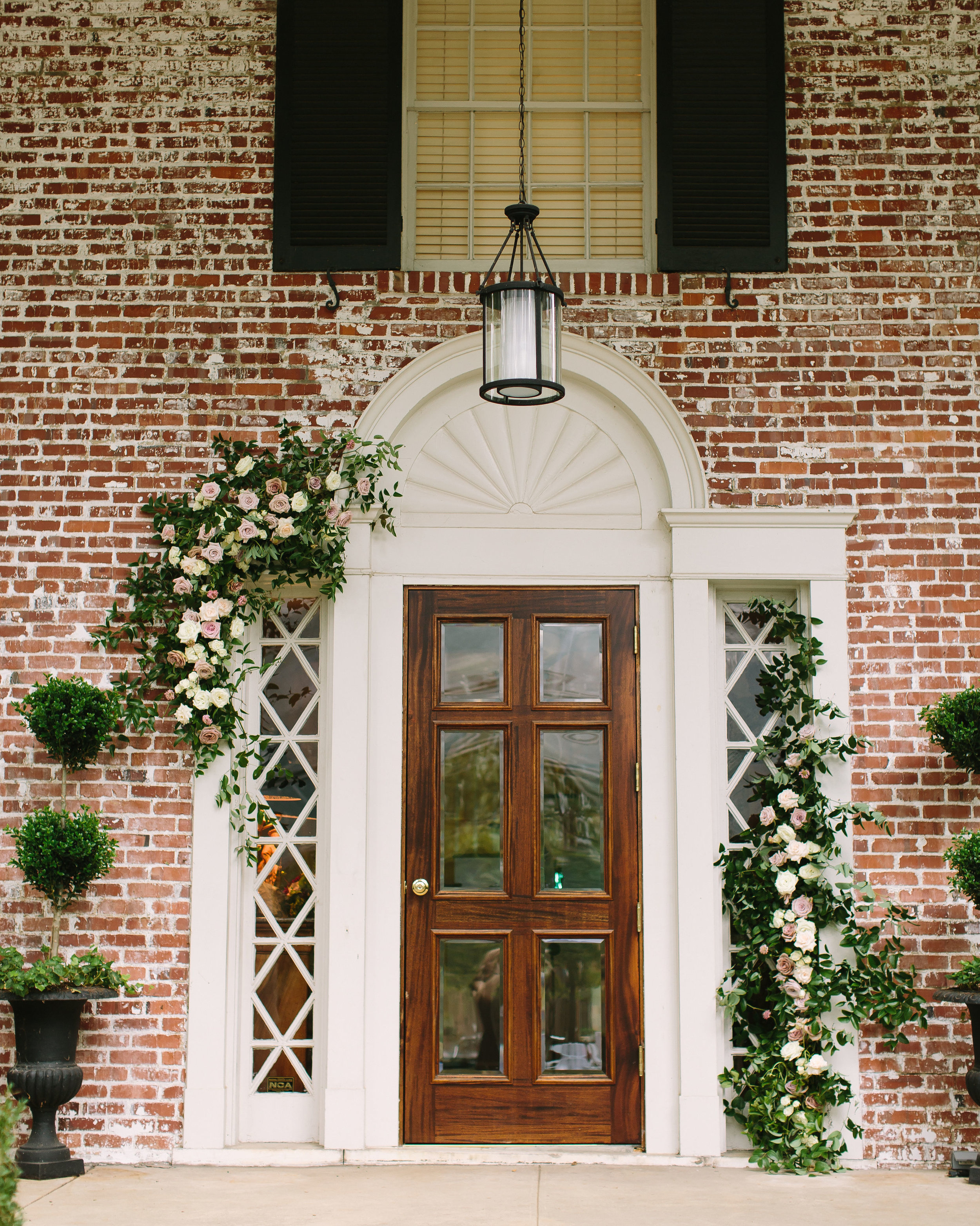 Natural floral installation on doorway // Belle Mead Backyard Wedding