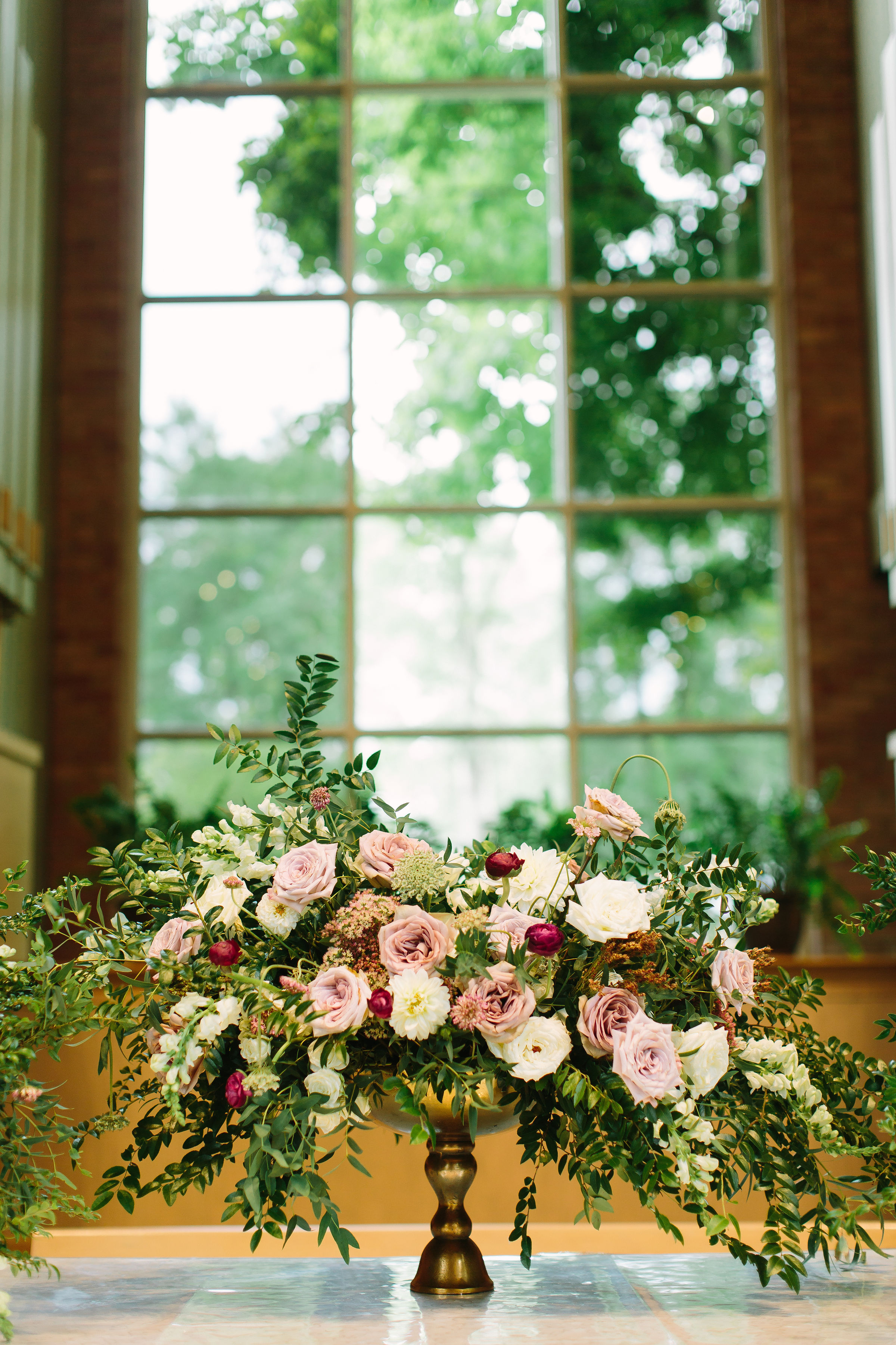 Lush, untamed altar arrangement with hues of dusty mauve, blush, and white // Nashville Wedding Floral Design