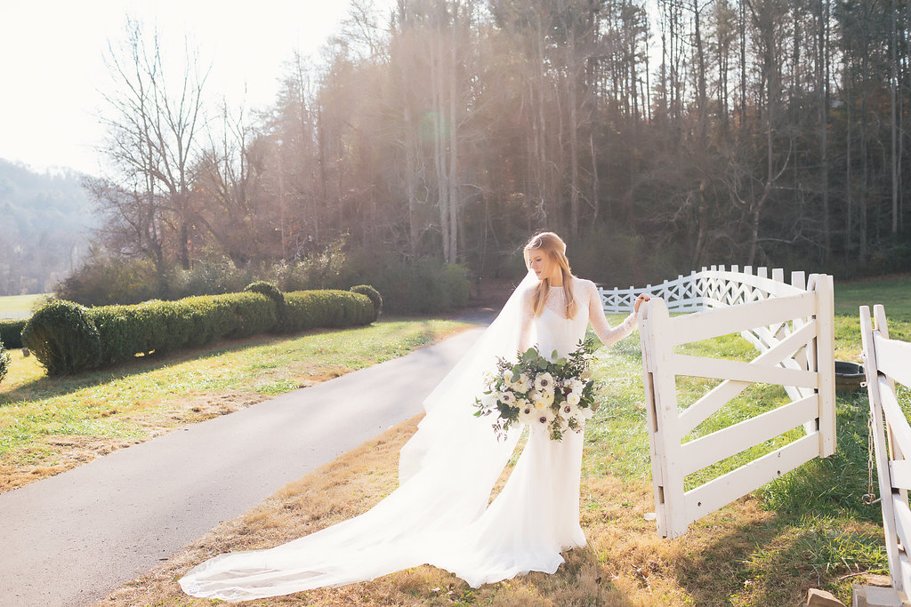 Lush all white and greenery bridal bouquet with anemones, sweet peas, garden roses, and tulips // Nashville Wedding Florist