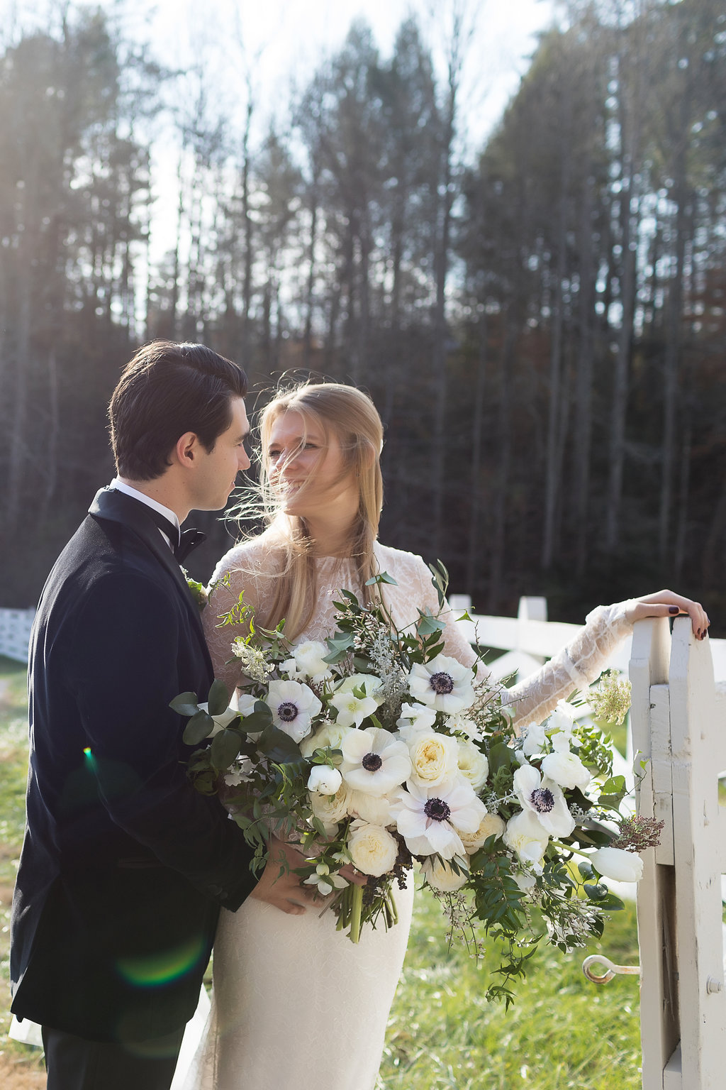 Lush all white and greenery bridal bouquet with anemones, sweet peas, garden roses, and tulips // Nashville Wedding Floral Designer