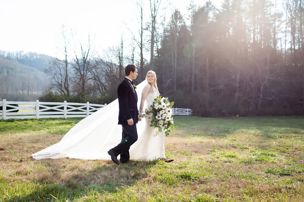 Oversized, asymmetrical bride’s bouquet with white flowers and natural, untamed greenery // Tennessee Wedding Floral Design at Blackberry Farm