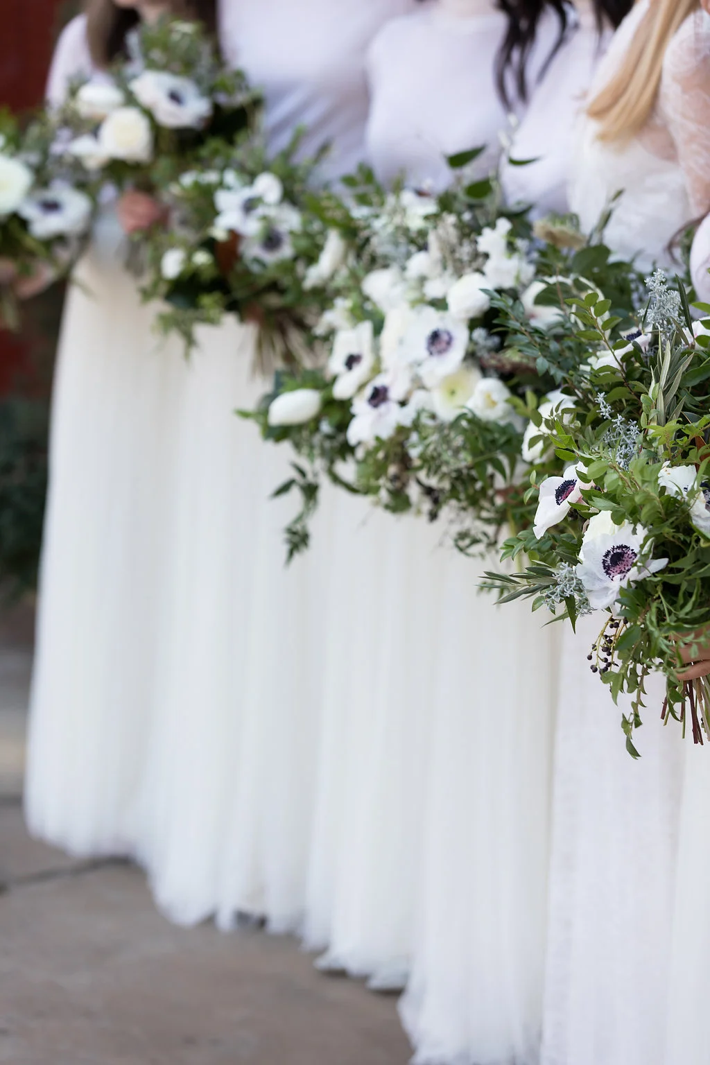 Natural, garden inspired wedding bouquets with white garden roses, anemones, tulips, ranunculus, and trailing greenery // Nashville, TN Wedding Floral Design