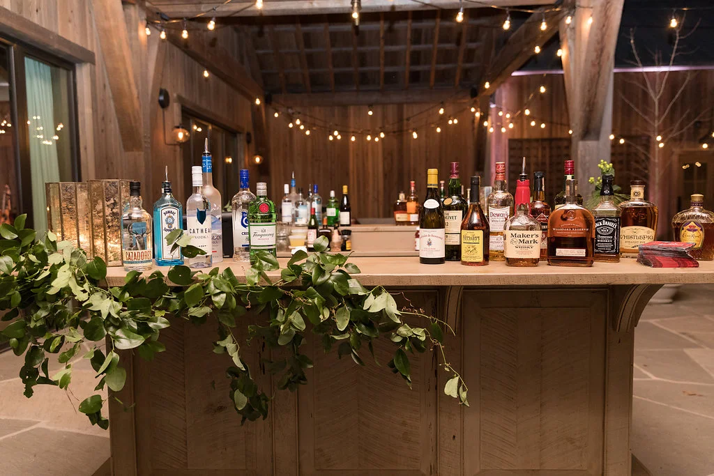 Natural greenery accenting the bar // Blackberry Farm wedding flowers by Rosemary & Finch Floral Design