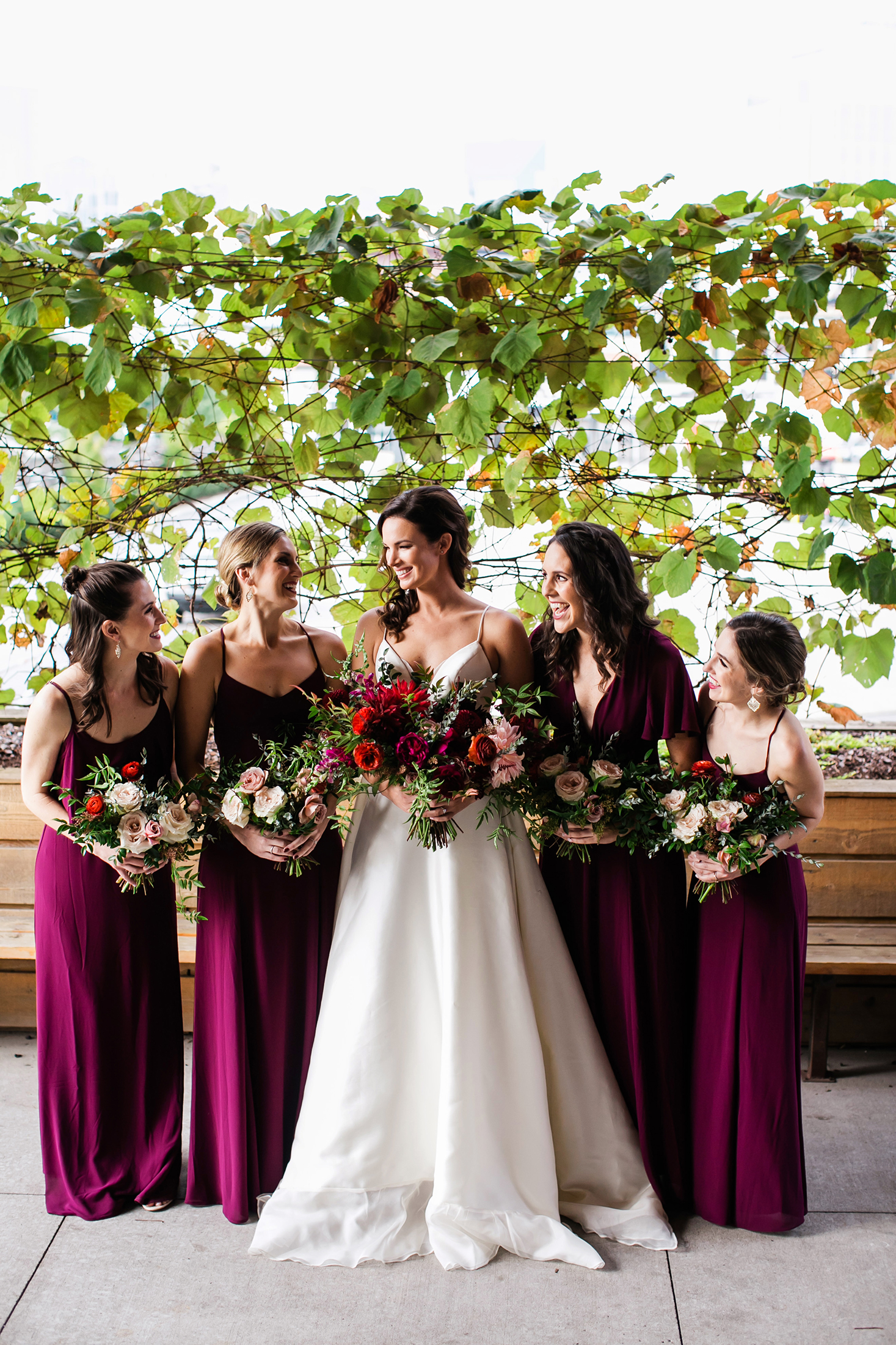 Bridesmaids in burgundy dresses with bouquets of marsala, blush, and greenery / Nashville Wedding Florist