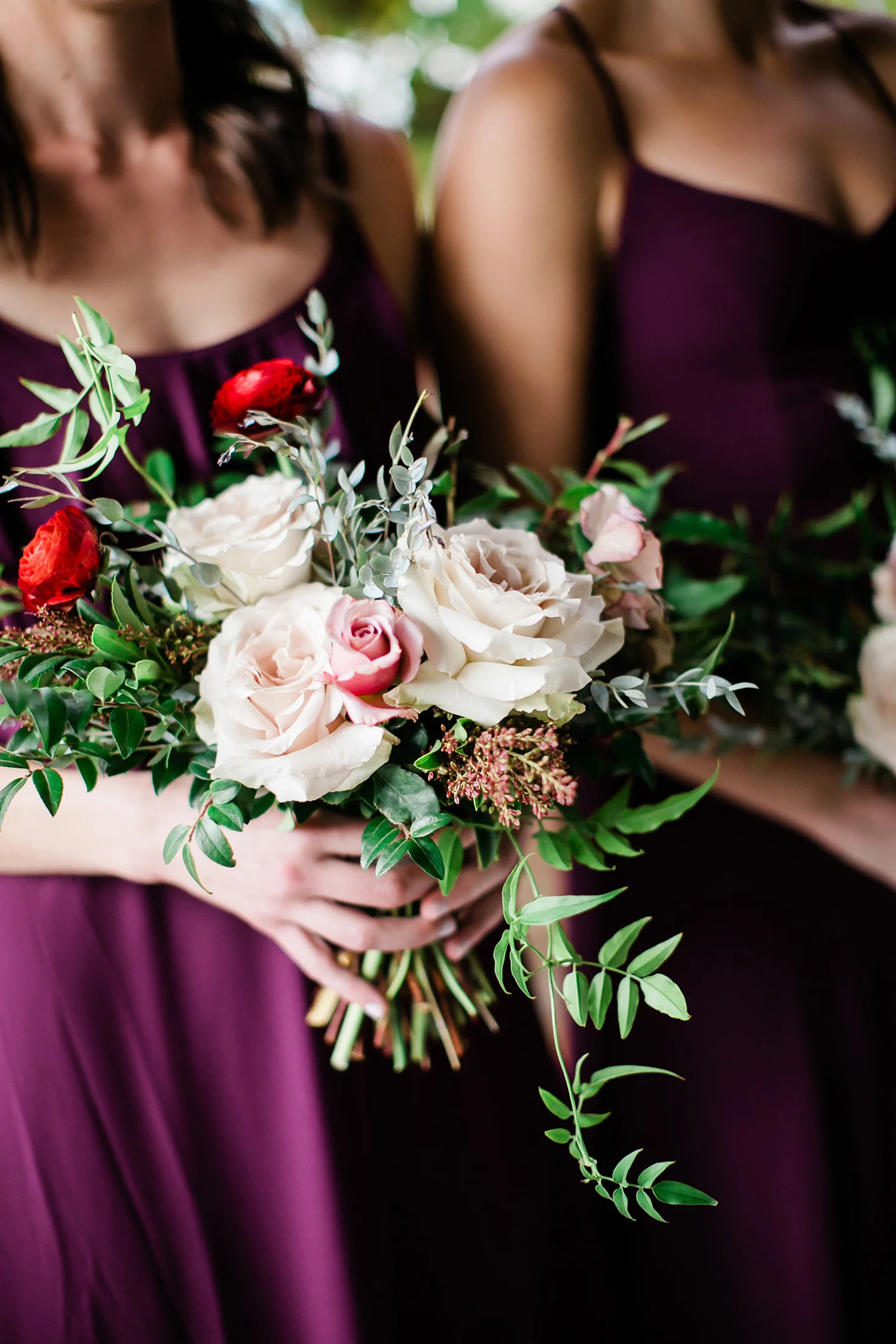 Bridesmaids in burgundy dresses with bouquets of marsala, blush, and greenery / Nashville Wedding Florist