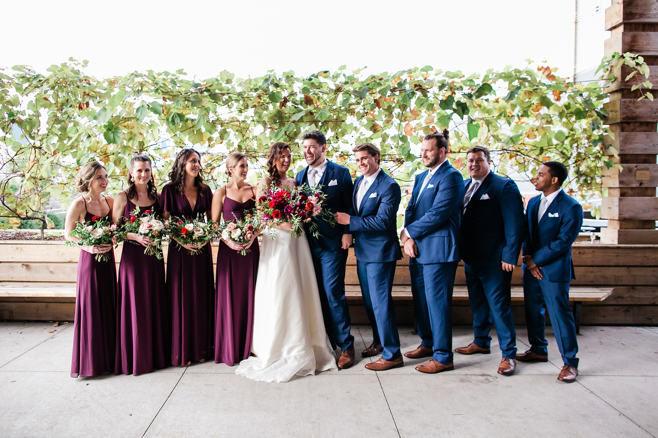 Bridesmaids in burgundy dresses with bouquets of marsala, blush, and greenery / Nashville Wedding Florist