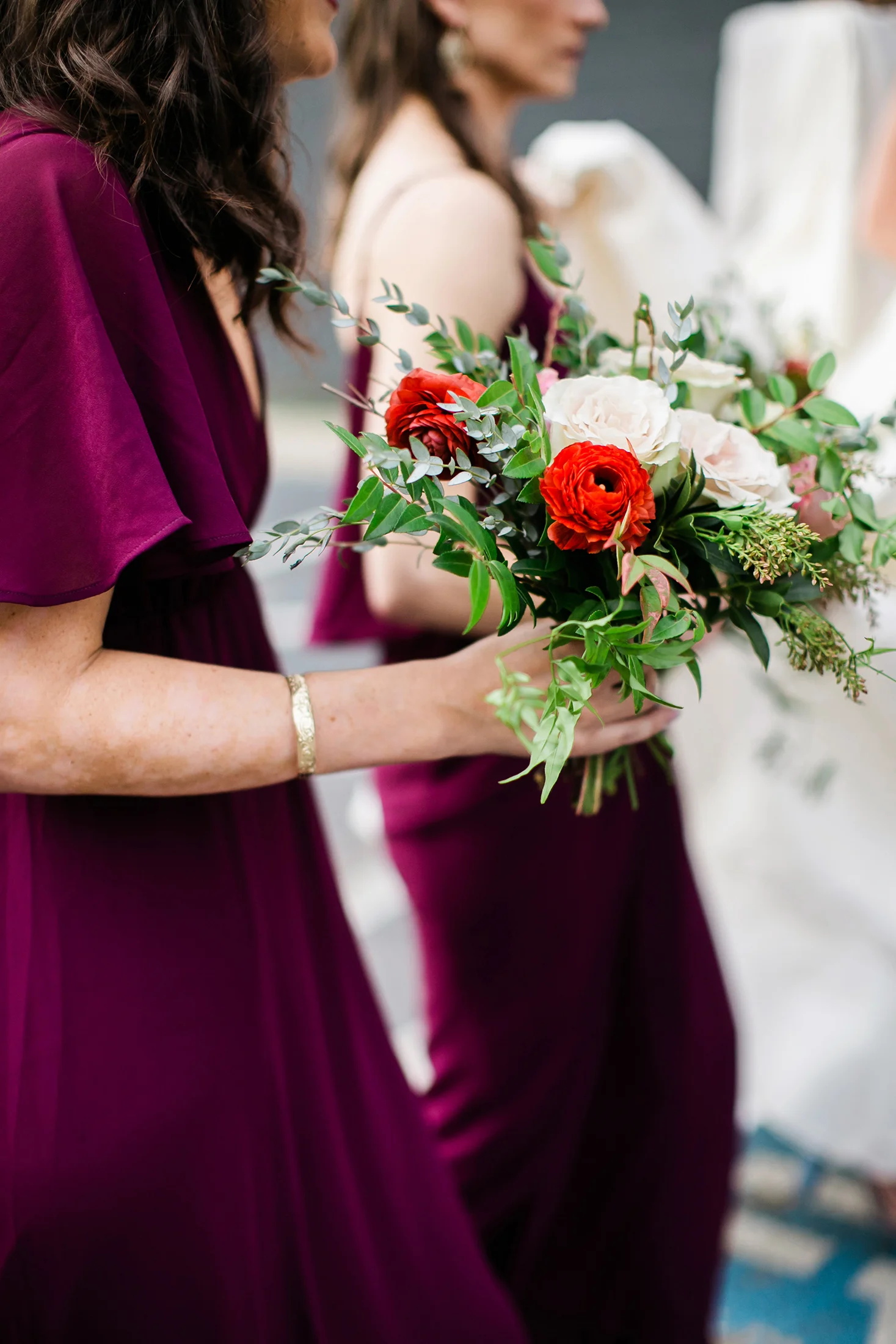 Bridesmaids in burgundy dresses with bouquets of marsala, blush, and greenery / Nashville Wedding Florist