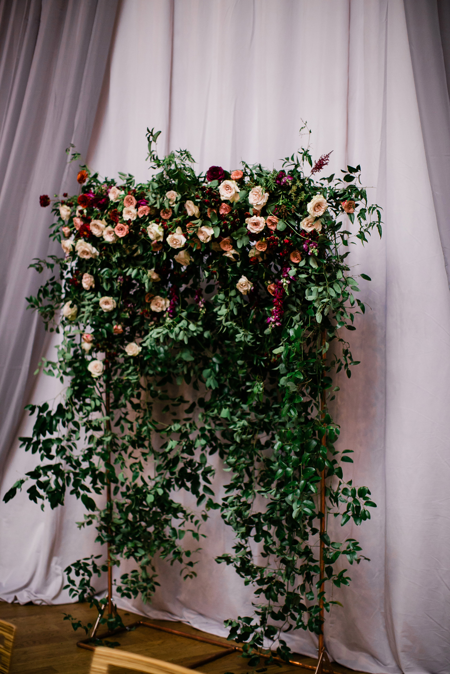 Flower wall for the wedding ceremony backdrop with lush greenery and burgundy and blush florals // Nashville Wedding Florist