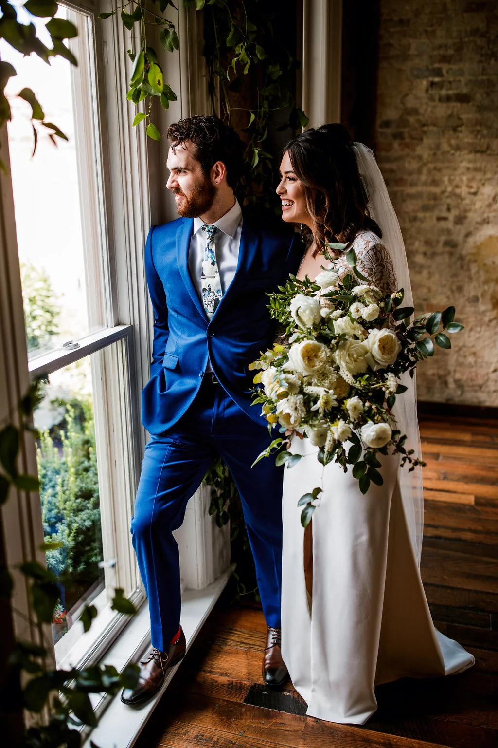Loose, natural bouquet of white garden roses, ranunculus, and dahlias with lush, trailing greenery // Nashville Wedding Floral Design at the Cordelle