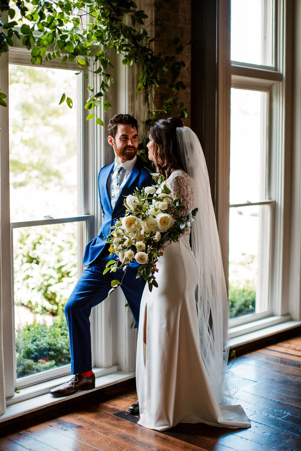 Loose, natural bouquet of white garden roses, ranunculus, and dahlias with lush, trailing greenery // Nashville Wedding Floral Design at the Cordelle
