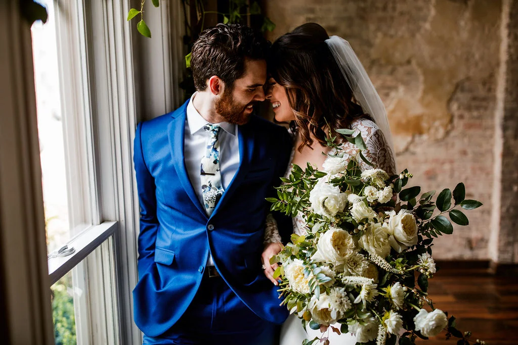 Loose, natural bouquet of white garden roses, ranunculus, and dahlias with lush, trailing greenery // Nashville Wedding Floral Design at the Cordelle