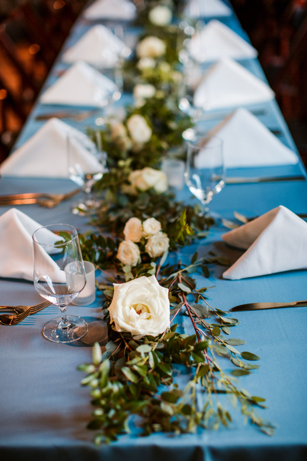 Eucalyptus garland table runners with floral accents of white and blush // TN Floral Designer