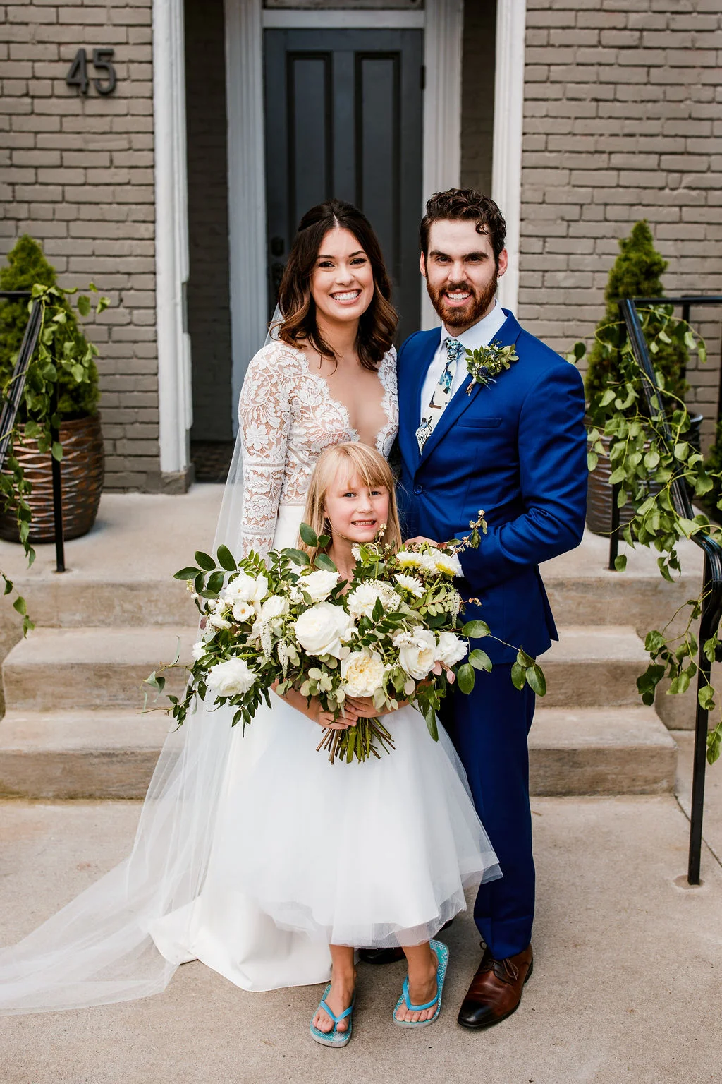 Loose, natural bouquet of white garden roses, ranunculus, and dahlias with lush, trailing greenery // Nashville Wedding Floral Design at the Cordelle