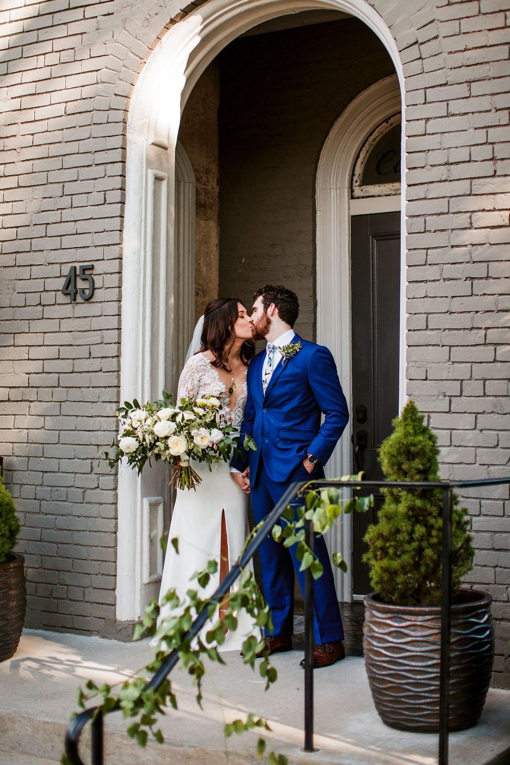 Loose, natural bouquet of white garden roses, ranunculus, and dahlias with lush, trailing greenery // Nashville Wedding Floral Design at the Cordelle
