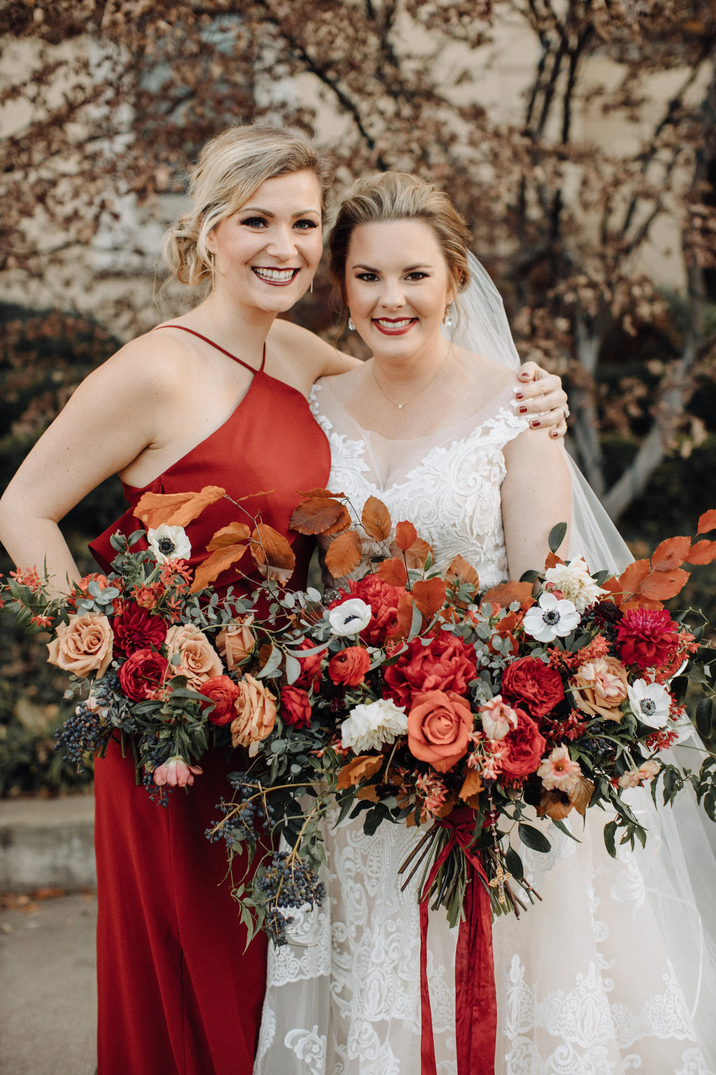 Burgundy velvet bridesmaid dresses with lush, asymmetrical bouquets using garden roses, ranunculus, and anemones