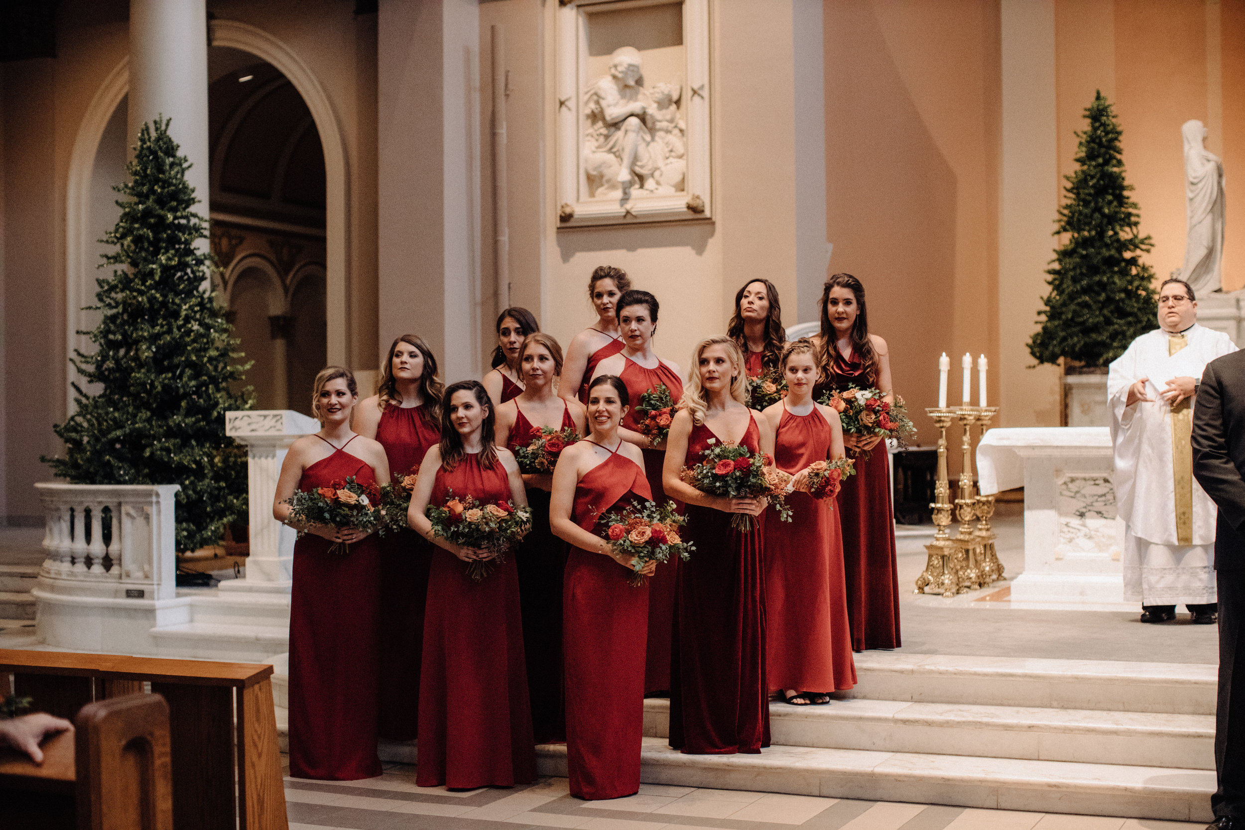 Burgundy velvet bridesmaid dresses with lush, asymmetrical bouquets using garden roses, ranunculus, and anemones. Nashville Wedding Floral Design at the Cathedral.