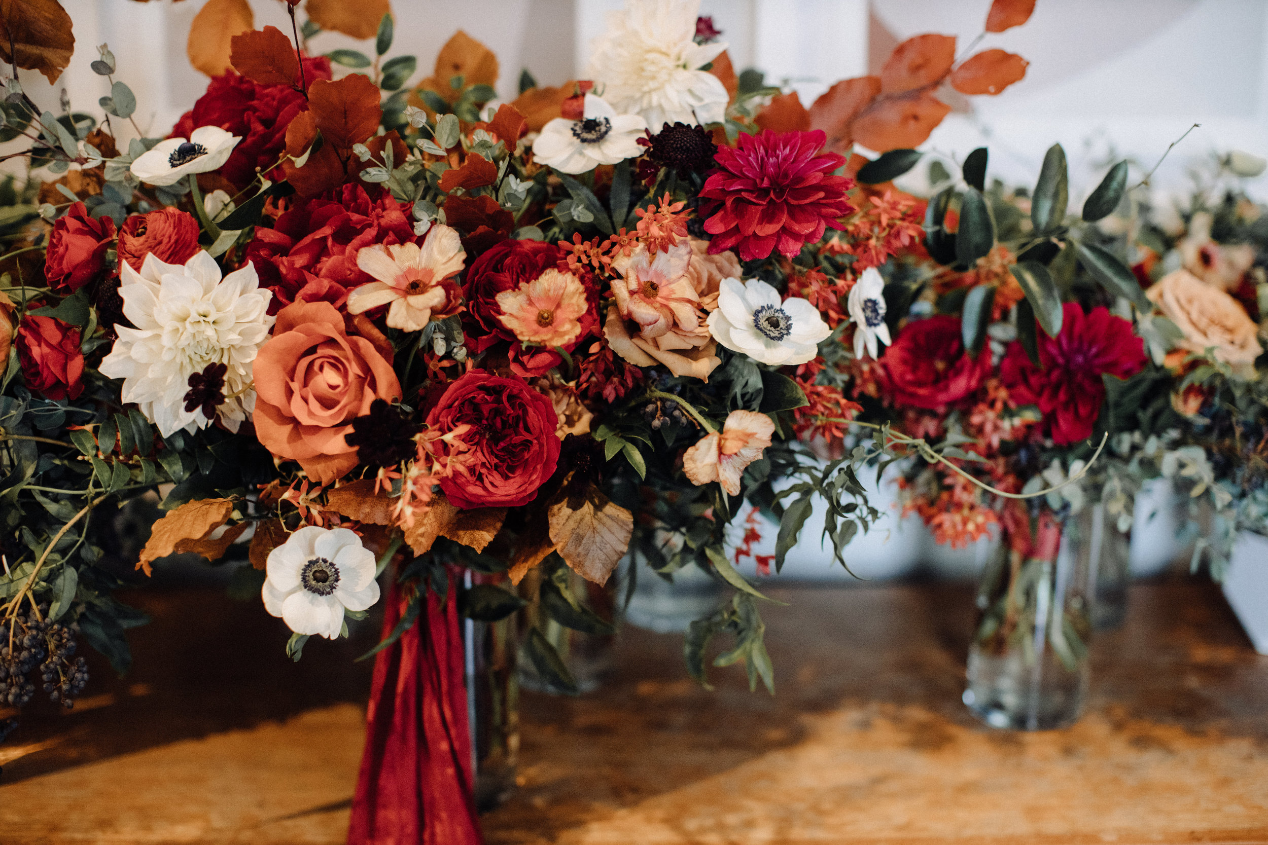 Lush bridal bouquet with autumn foliage, anemones, dahlias, and garden roses. Nashville Wedding Floral Design.