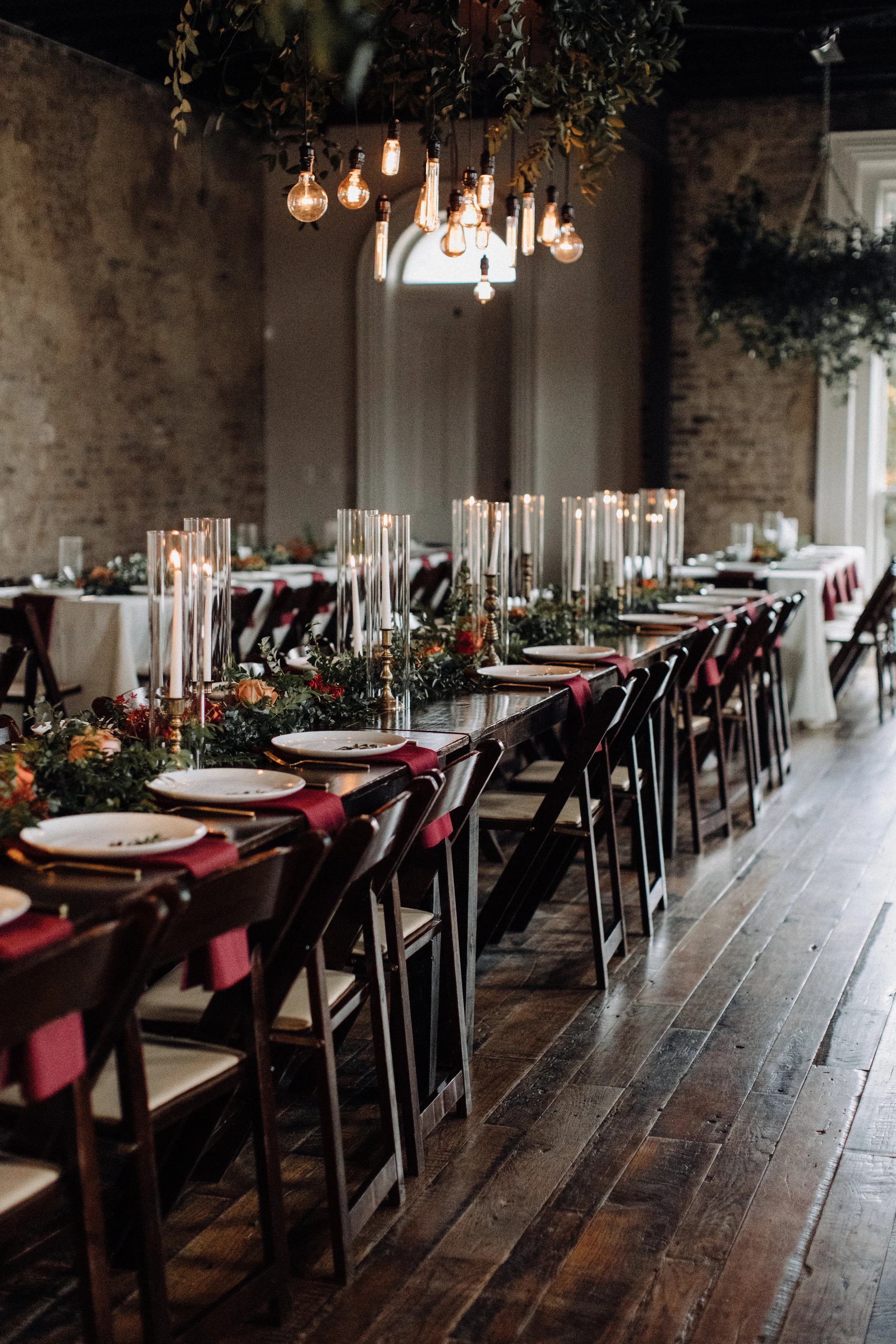 Fall wedding party style with deep reds and touches of burnt orange. Nashville Wedding Florist.  Autumnal bridesmaid bouquets with burgundy and soft orange and lots of greenery and berries. Tennessee Wedding Flowers.  Burgundy velvet bridesmaid dres…