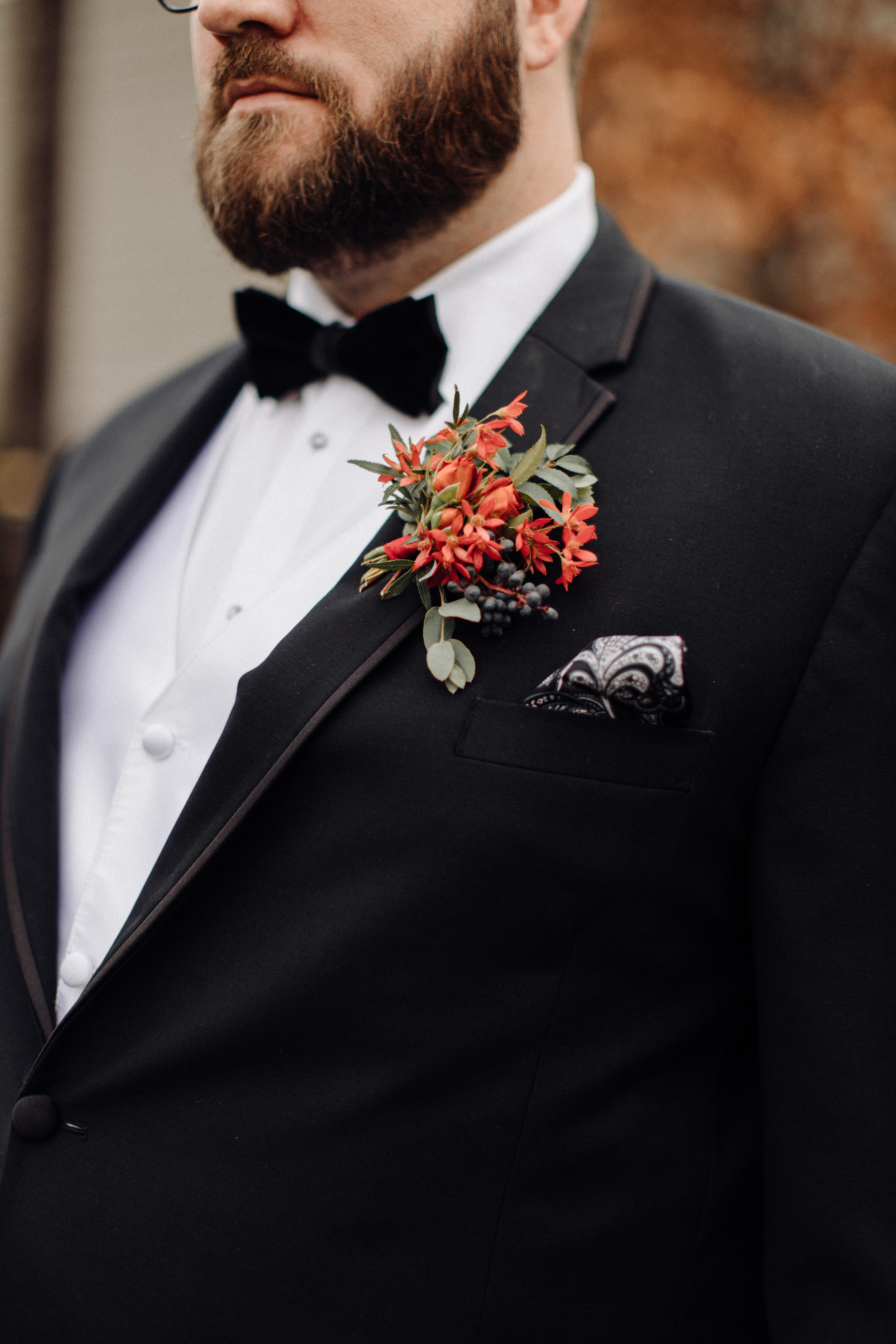 Autumnal groom boutonniere with berries, greenery, and texture. Southeastern US Wedding Floral Design.