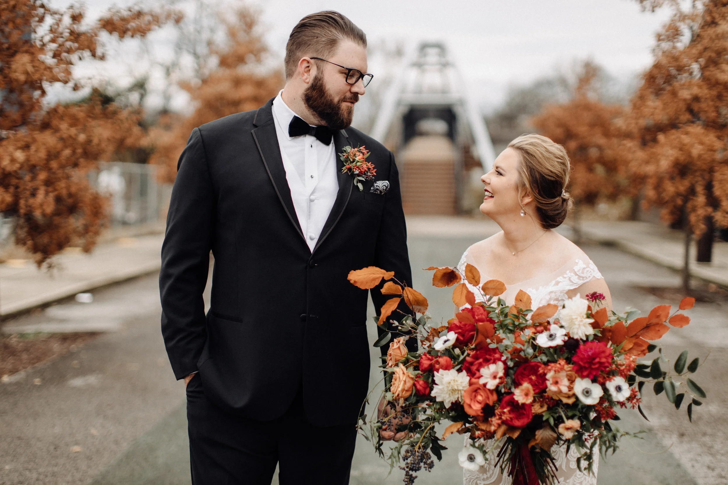 Lush bridal bouquet with autumn foliage, anemones, dahlias, and garden roses. Nashville Wedding Floral Design.