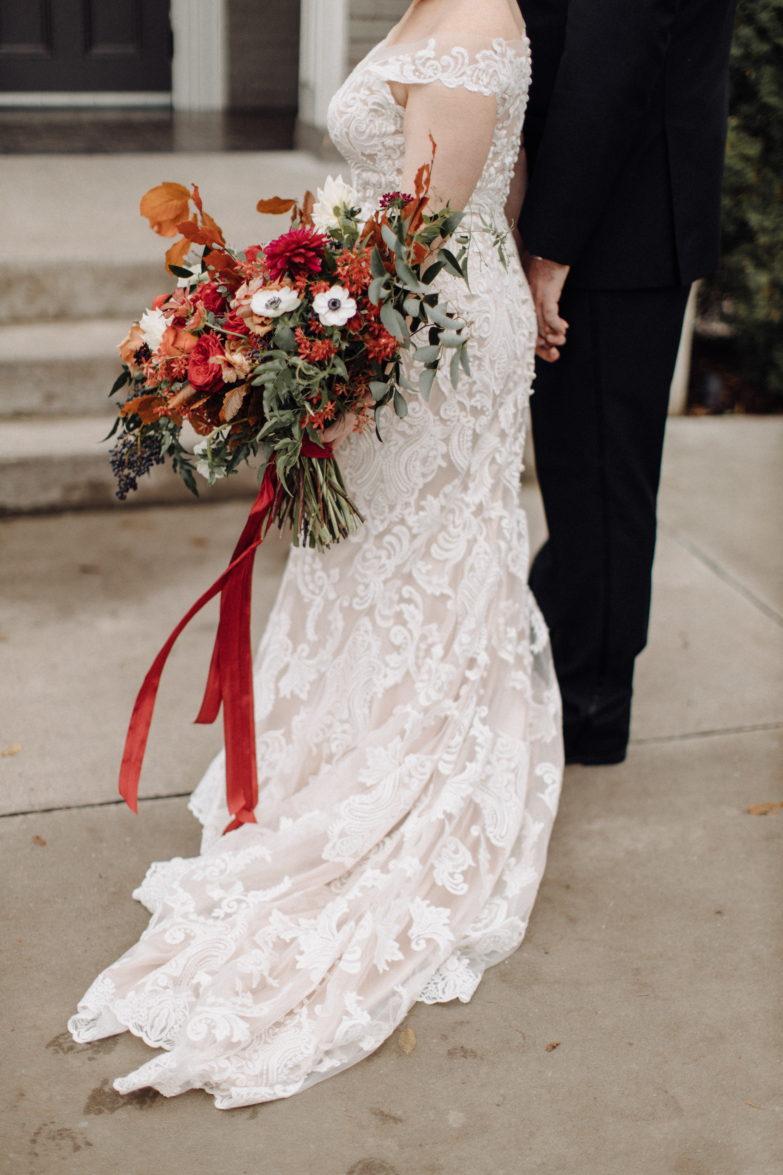 Lush bridal bouquet with autumn foliage, anemones, dahlias, and garden roses. Nashville Wedding Floral Design.