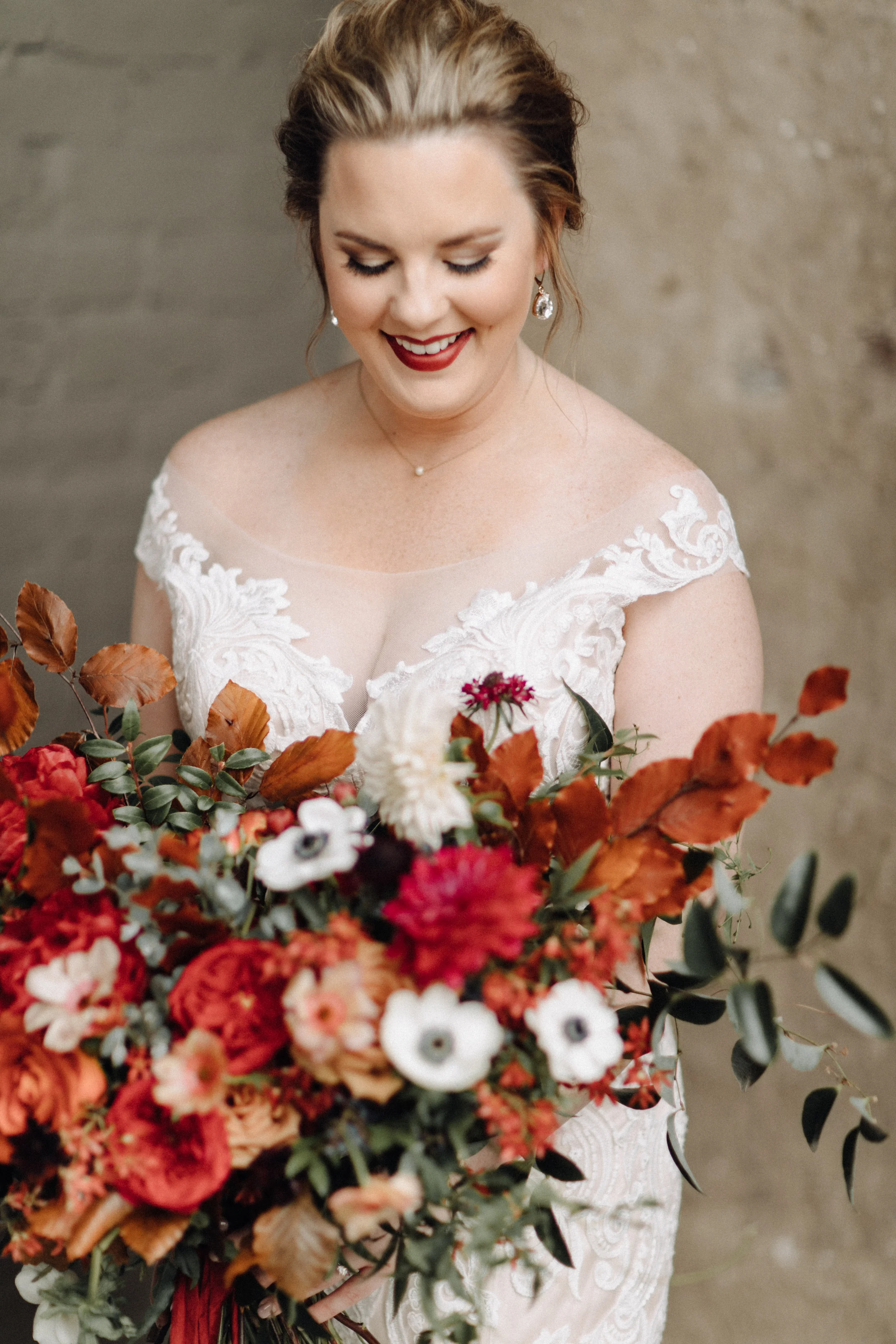 Airy, untamed bride’s bouquet of lush greenery, berries and textures, burgundy  peonies, burnt orange garden roses, anemones, and dahlias. Nashville Wedding Floral Design at the Cordelle.