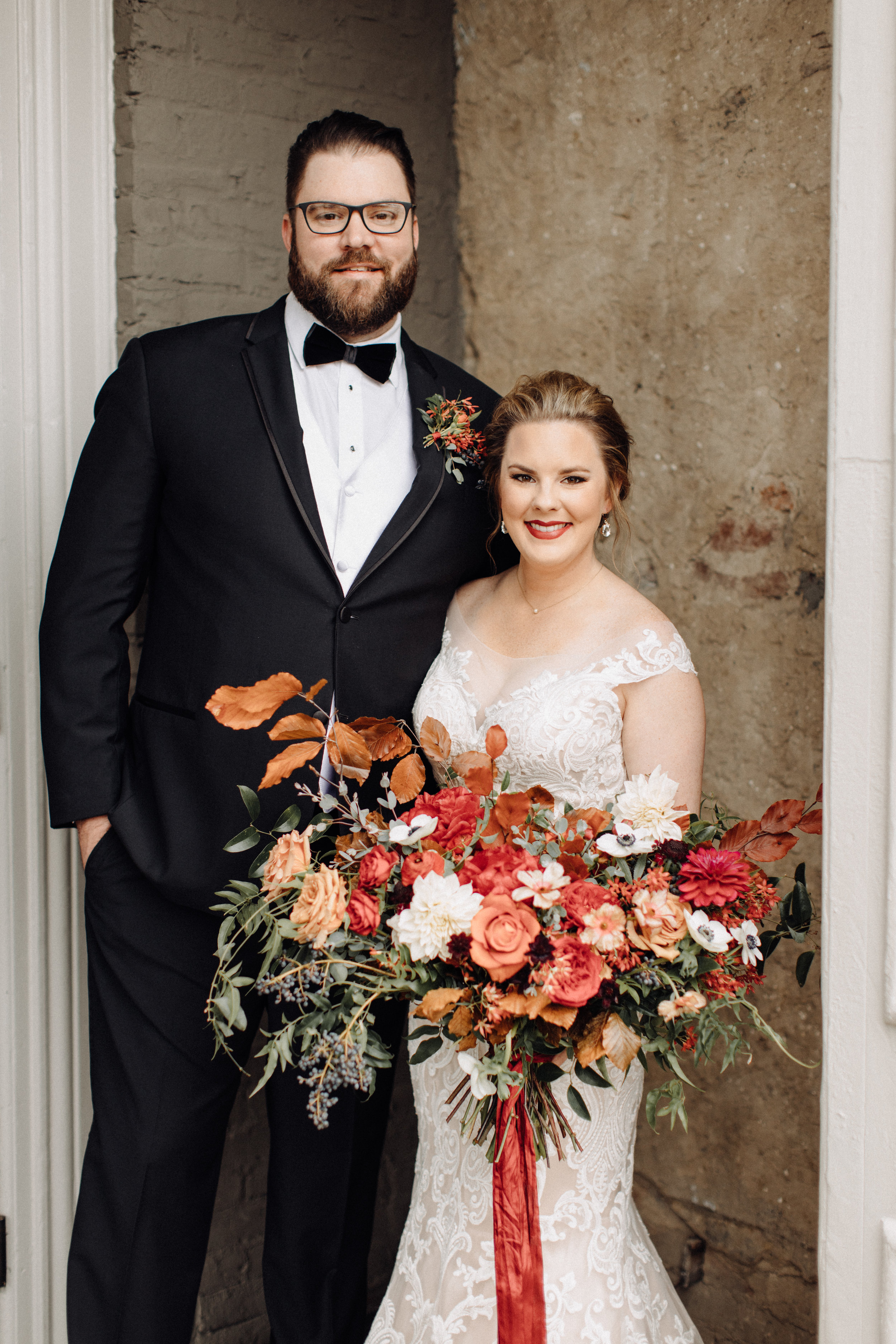 Airy, untamed bride’s bouquet of lush greenery, berries and textures, burgundy  peonies, burnt orange garden roses, anemones, and dahlias. Nashville Wedding Floral Design at the Cordelle.