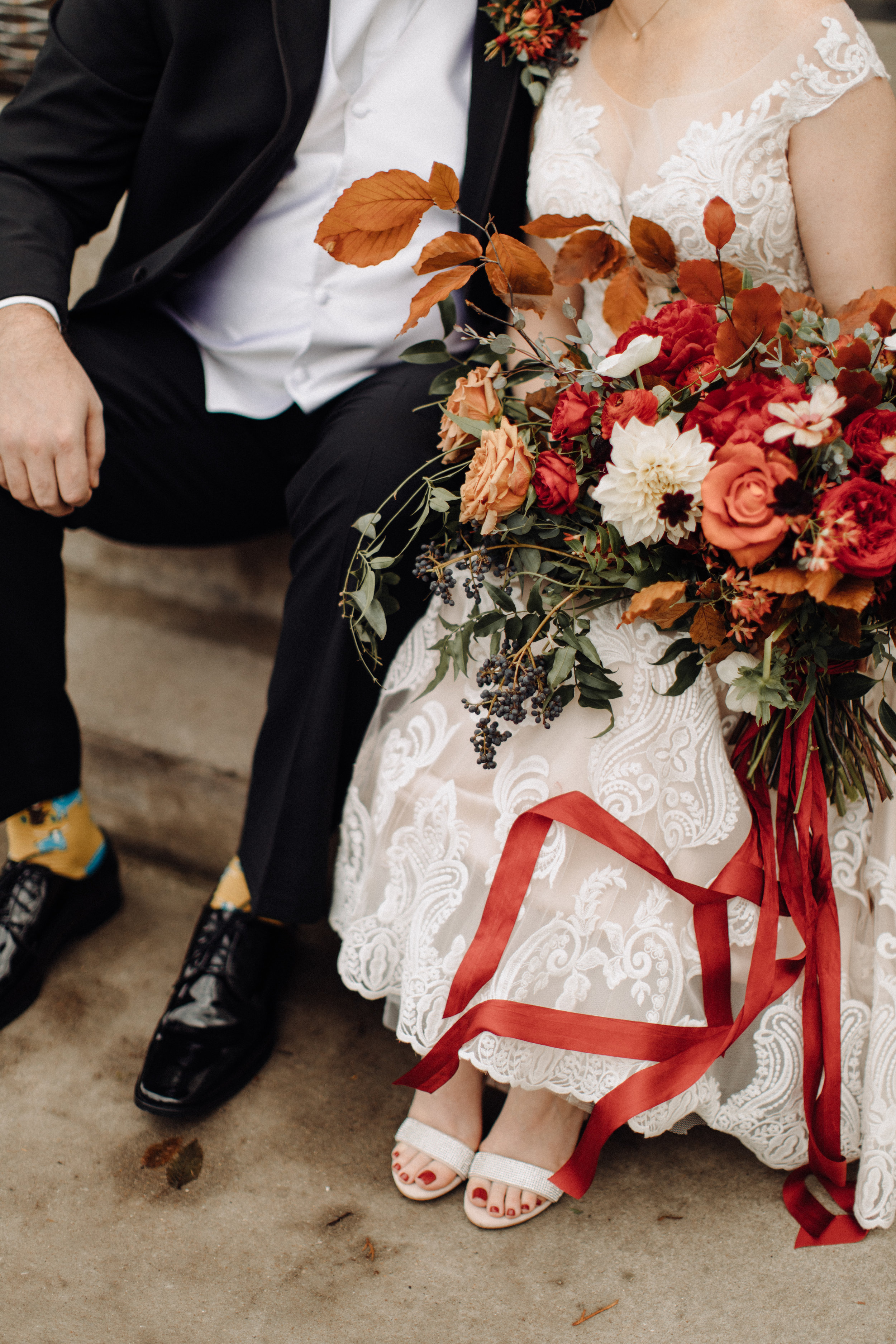 Airy, untamed bride’s bouquet of lush greenery, berries and textures, burgundy  peonies, burnt orange garden roses, anemones, and dahlias. Nashville Wedding Floral Design at the Cordelle.