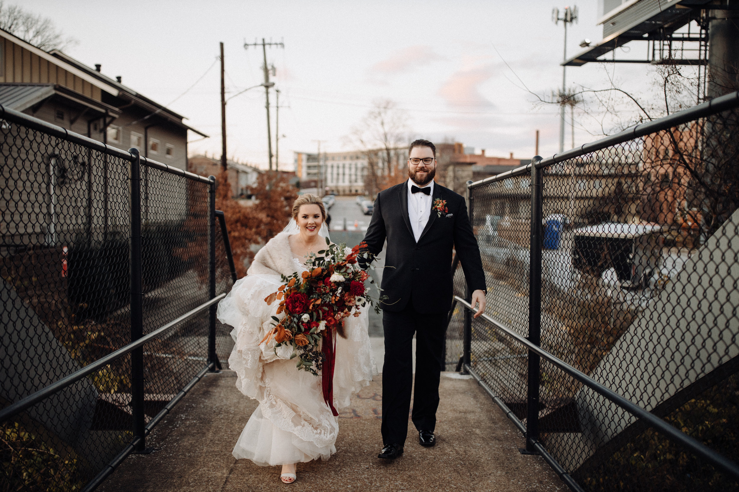 Airy, untamed bride’s bouquet of lush greenery, berries and textures, burgundy  peonies, burnt orange garden roses, anemones, and dahlias. Nashville Wedding Floral Design at the Cordelle.