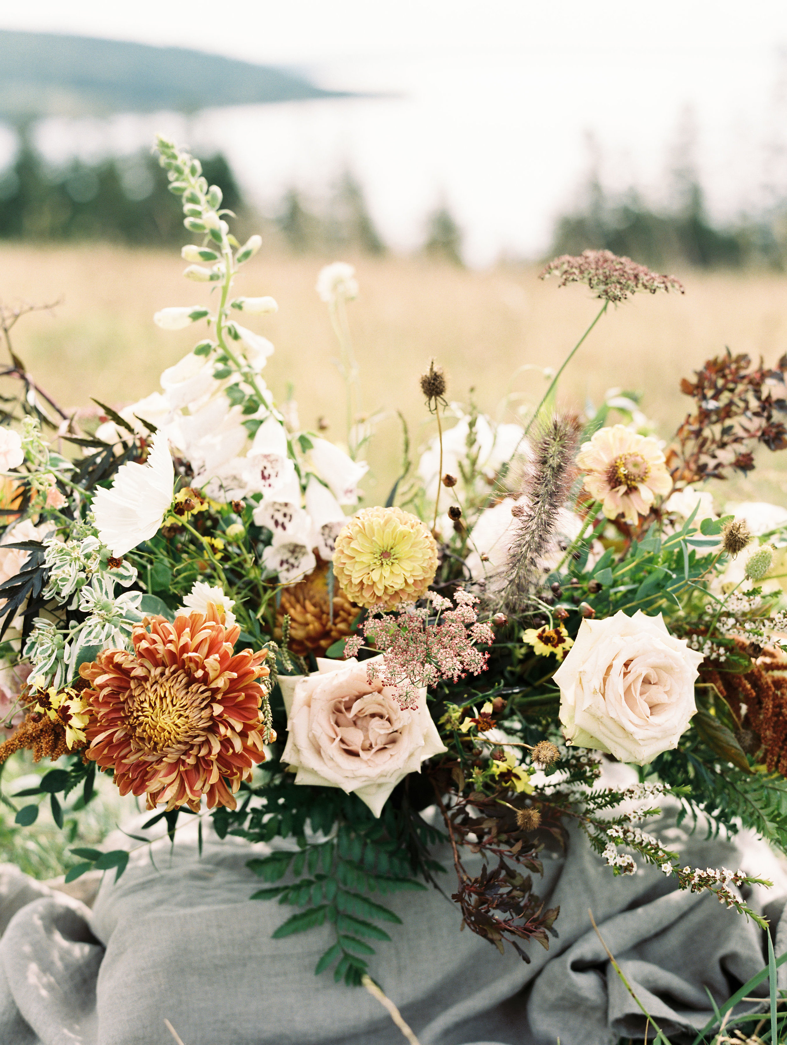 Organic, airy centerpiece of wildflowers and garden roses in muted earth tones. Nashville Wedding Florist