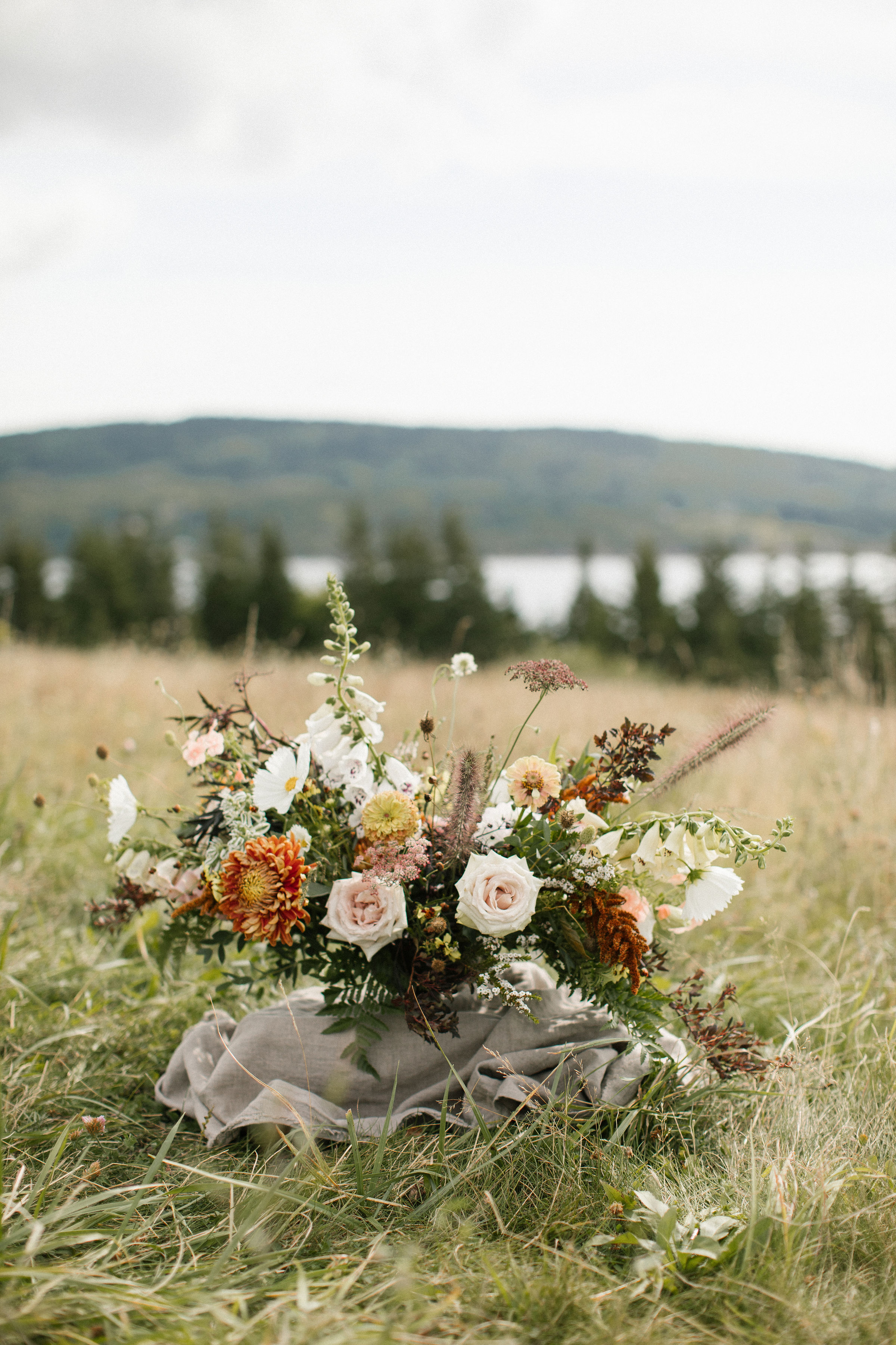 Organic, airy centerpiece of wildflowers and garden roses in muted earth tones. Nashville Wedding Florist