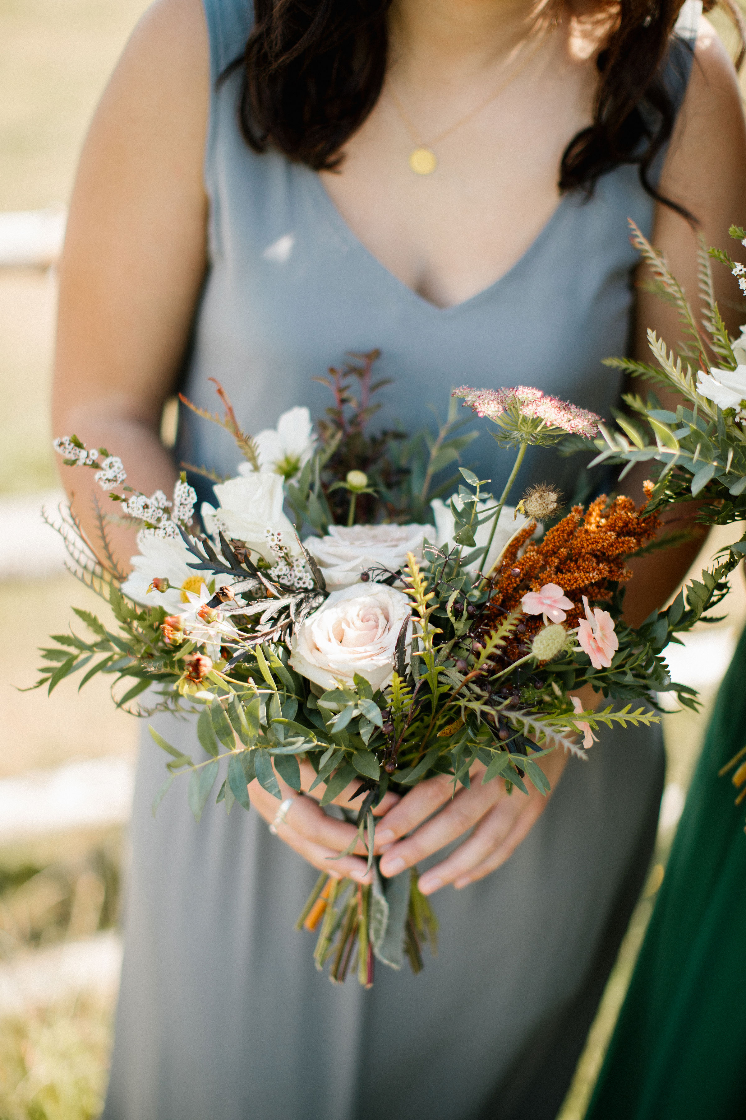 Lush bridesmaid bouquets in muted hues with wildflowers, greenery, and garden roses. Tennessee Wedding Florist