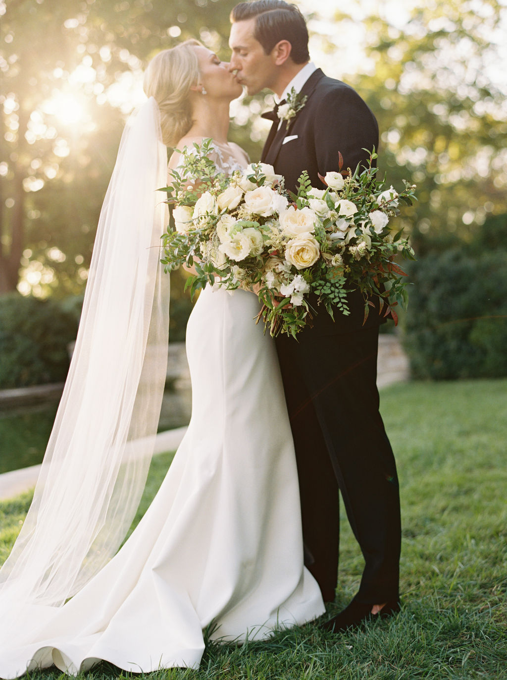 Untamed, asymmetrical bride’s bouquet with all white flowers and natural greenery. Southeast US Wedding Floral Design.